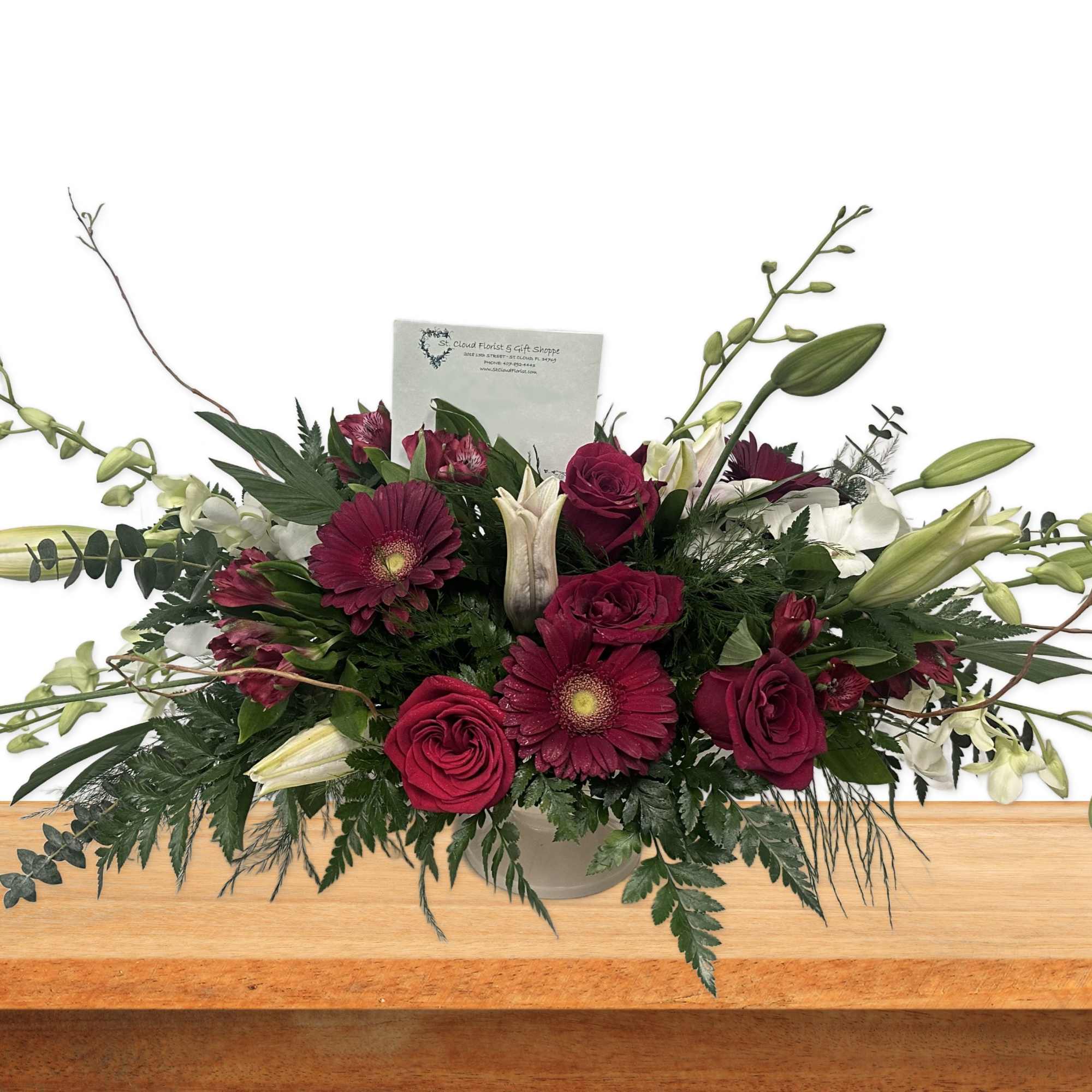 Long floral arrangement with burgundy roses and lilies in a vase