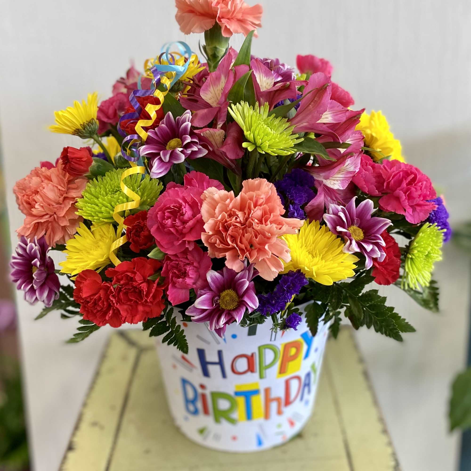 Colorful mixed bouquet in a birthday bucket