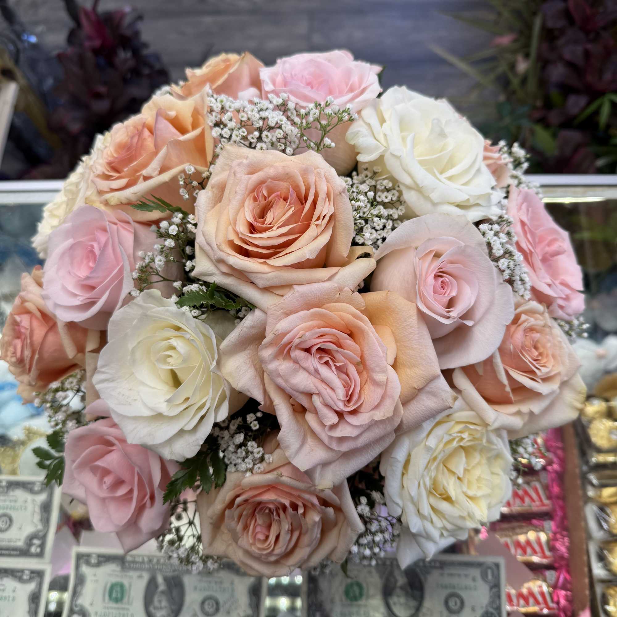 Bouquet of blush, peach, and white roses with baby's breath