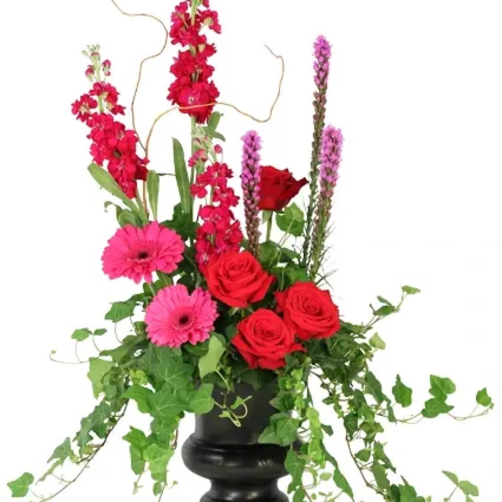 Peaceful Adornment features an ivy plant surrounded by beautiful hot pink roses