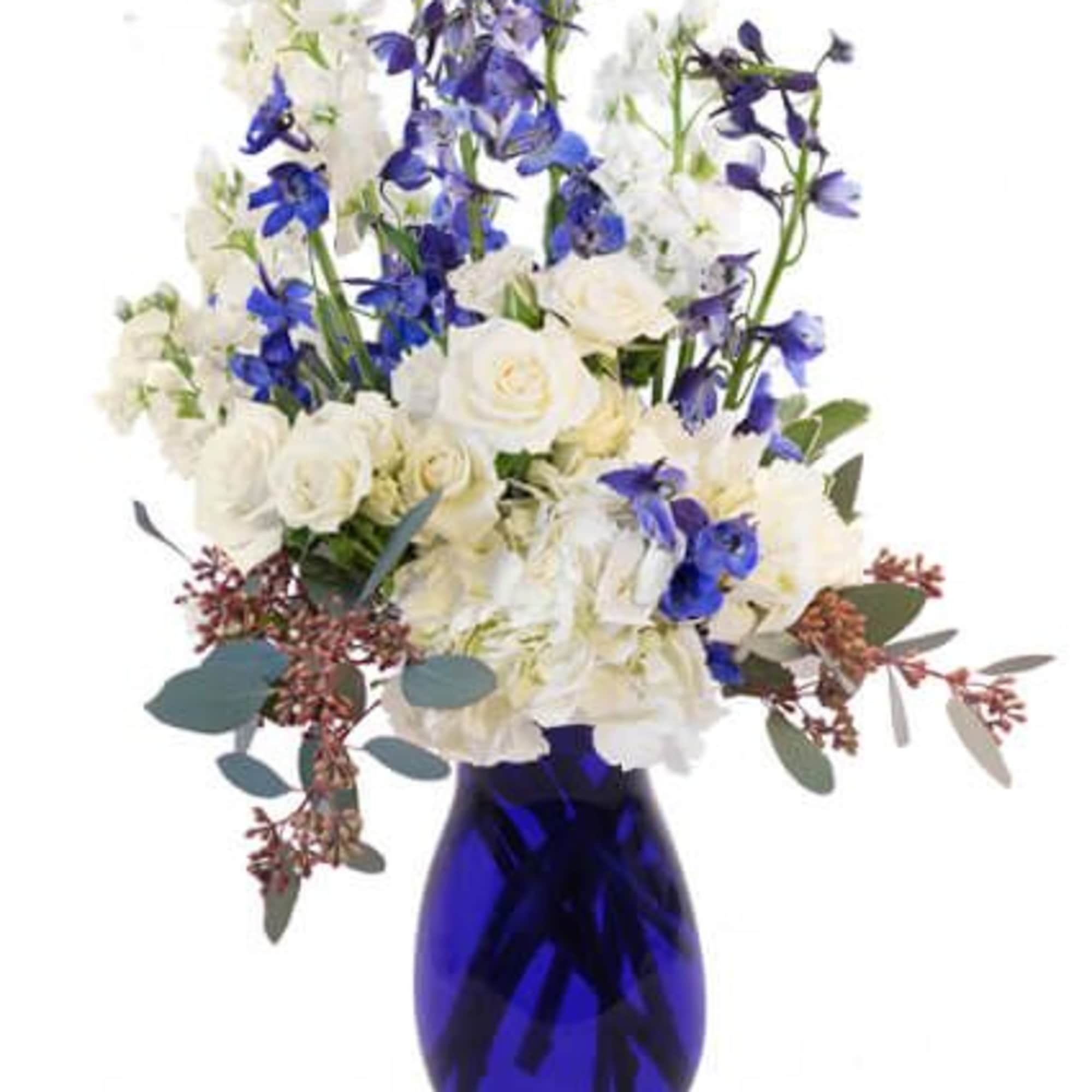 This charming arrangement is sure to delight! The gorgeous blue larkspur stands