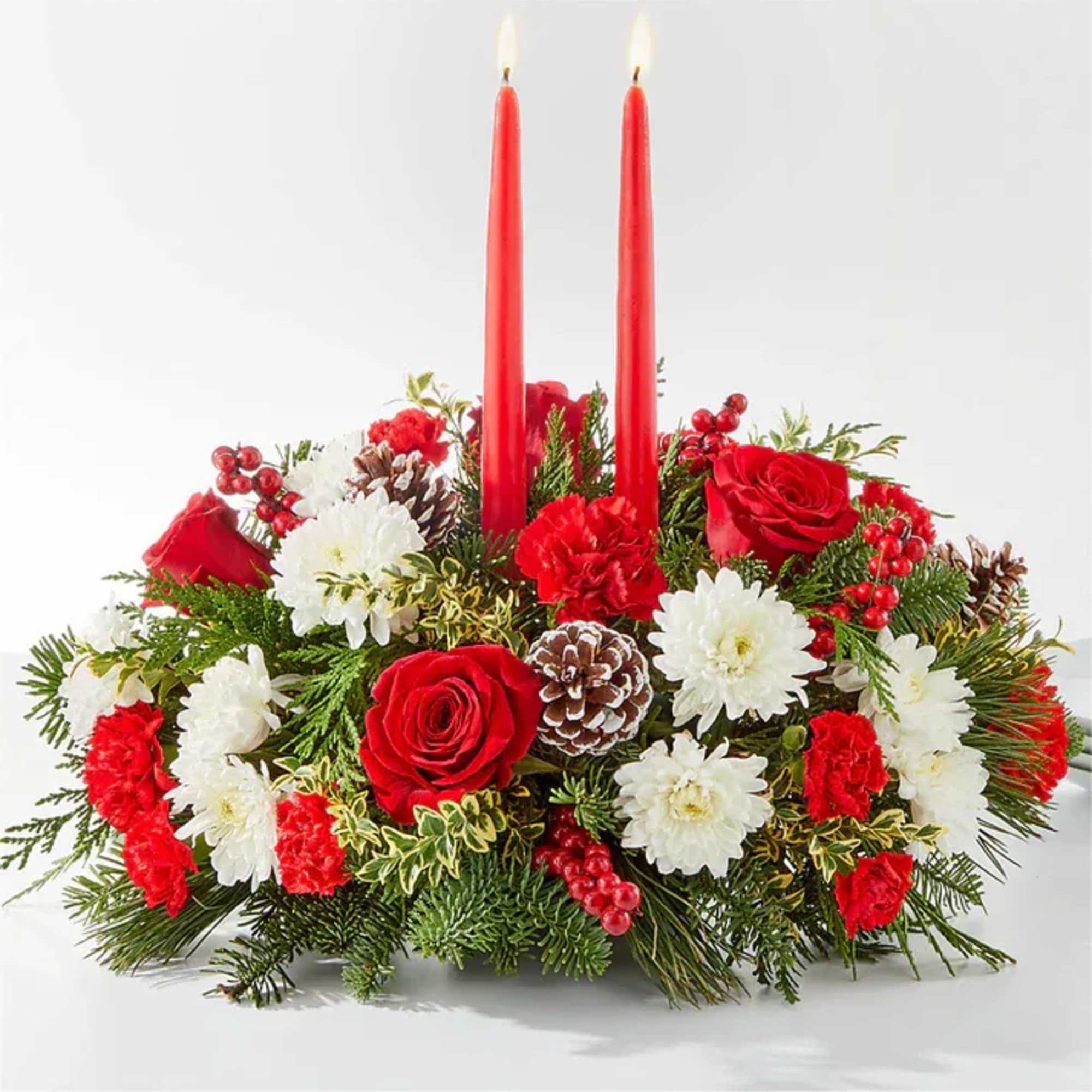 Red and white floral centerpiece with two red candles