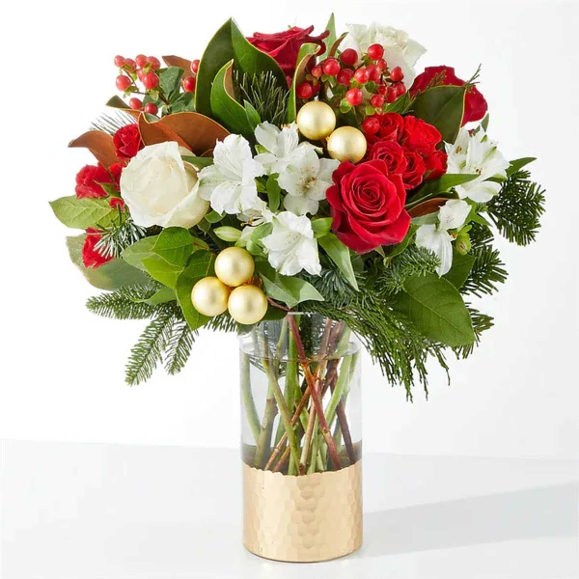 Red and white rose bouquet in a clear vase with gold ornaments