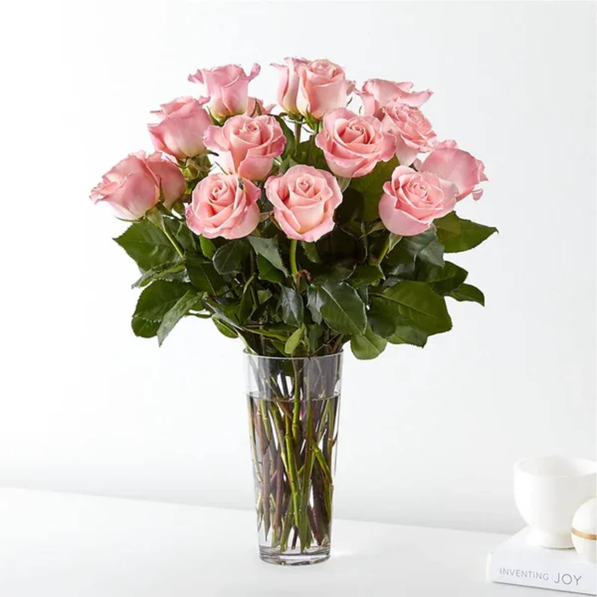 Pink roses arranged in a clear glass vase