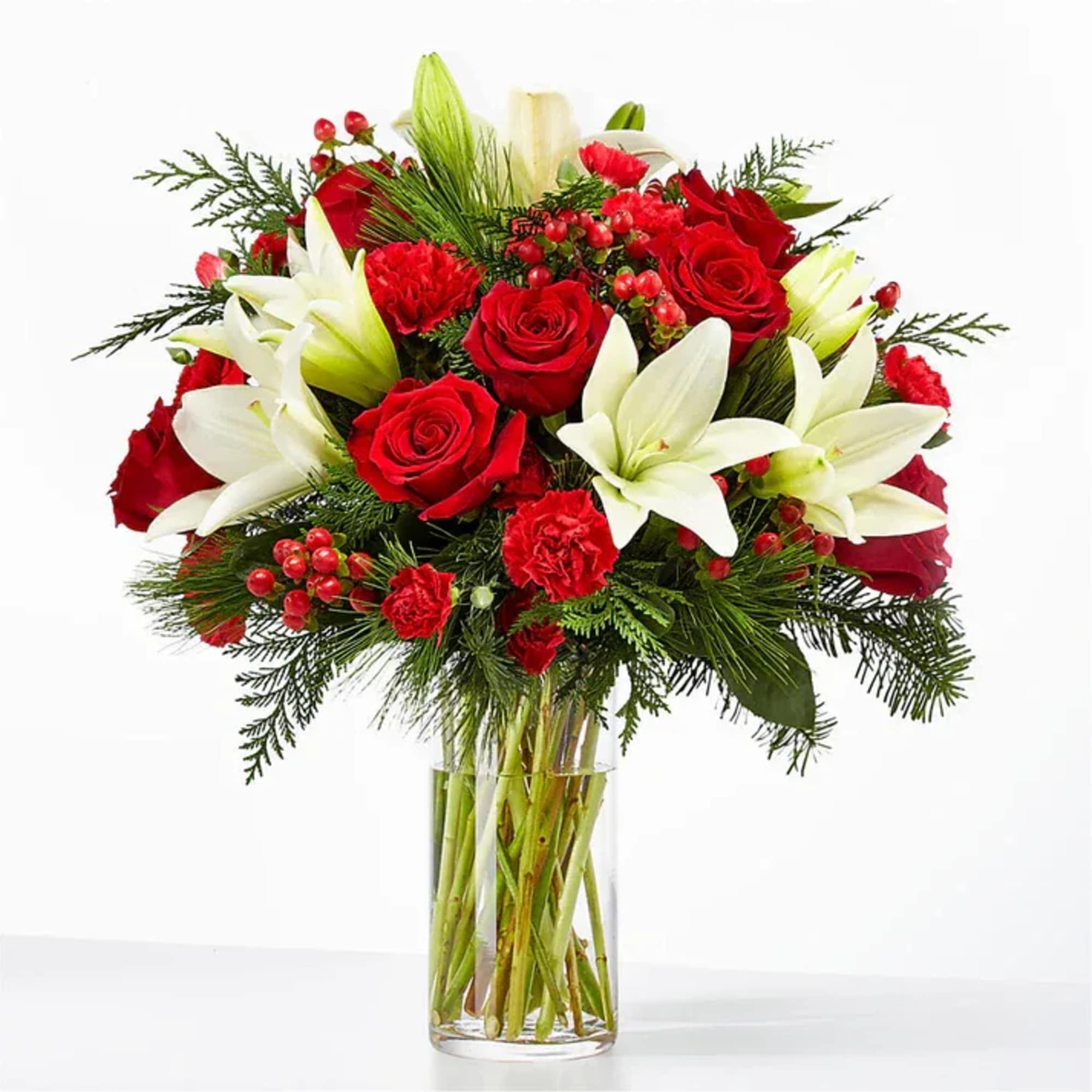 Red roses and white lilies arranged in a clear glass vase