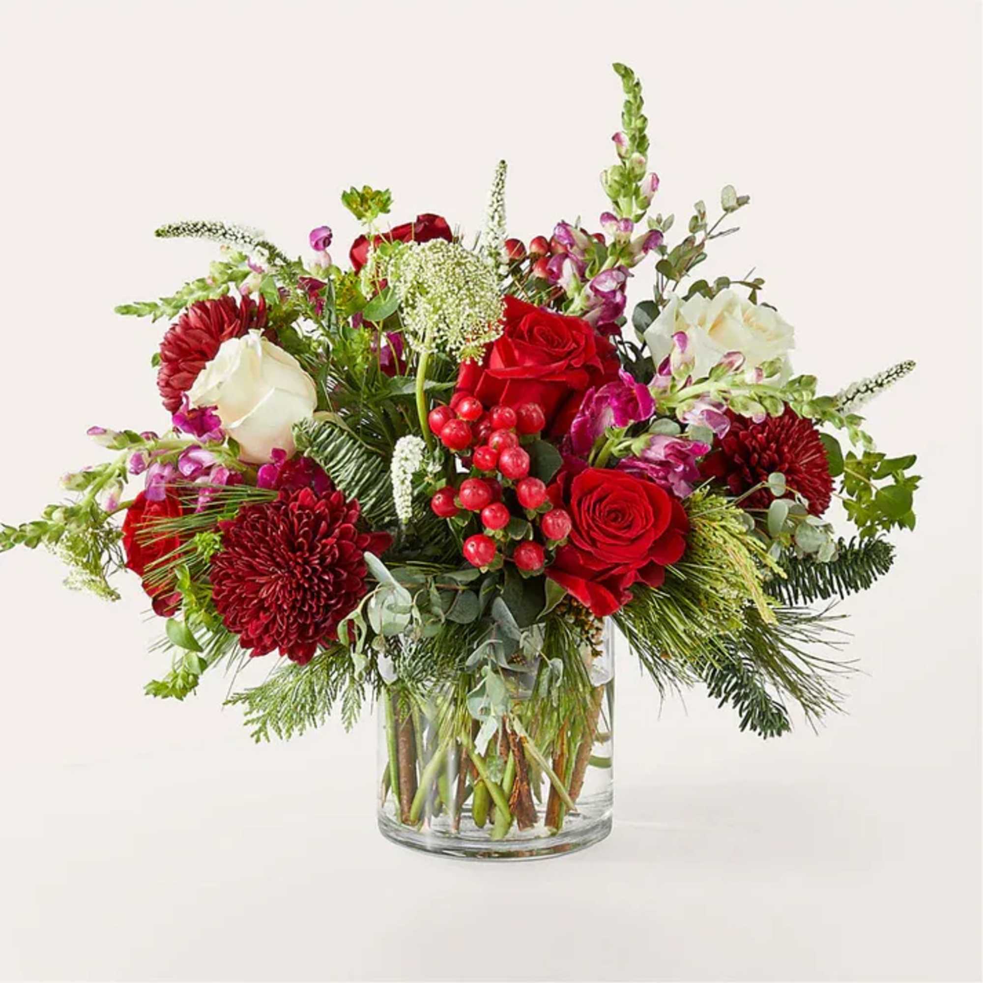 Red and white floral arrangement in a clear glass vase