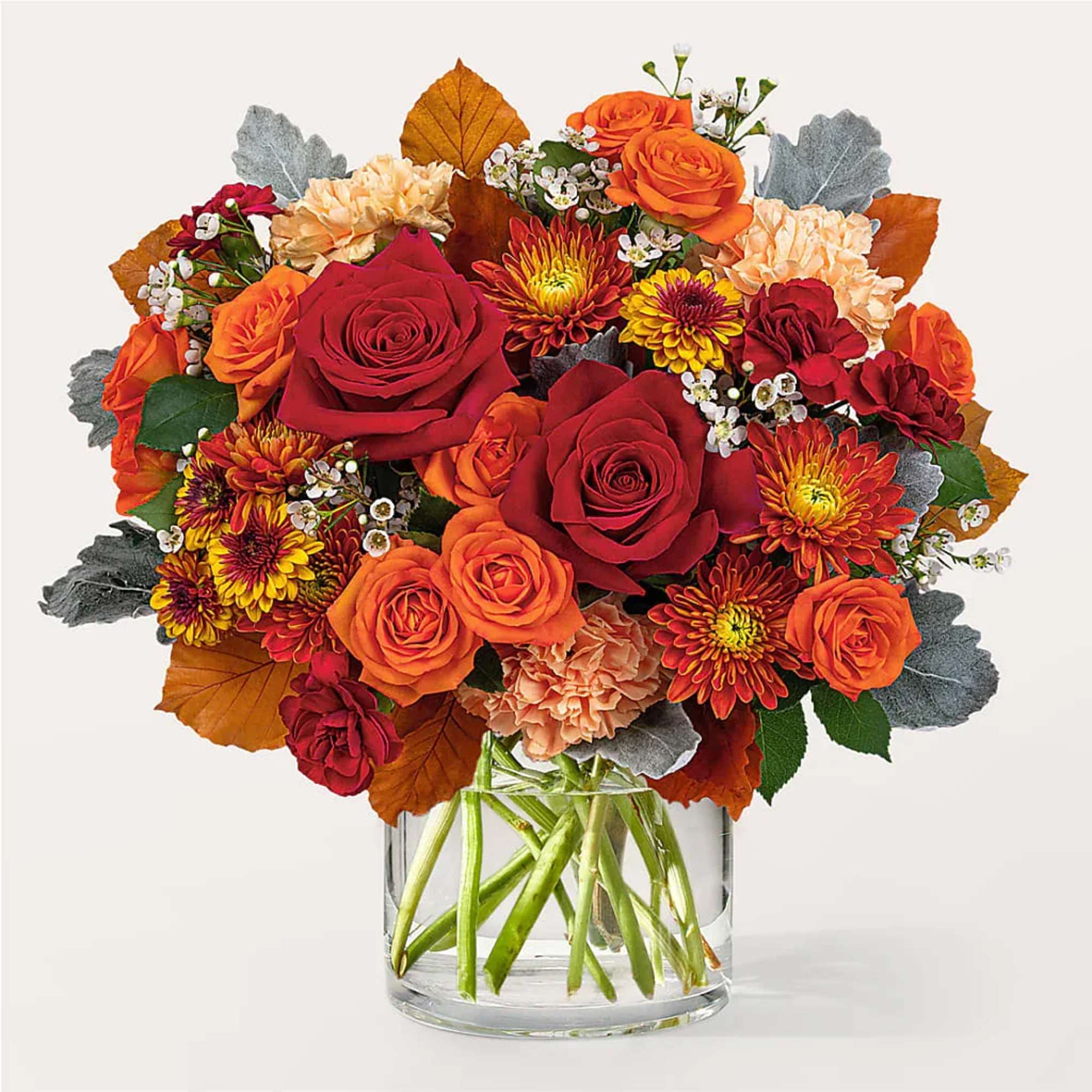 Bouquet of red and orange flowers in a clear glass vase