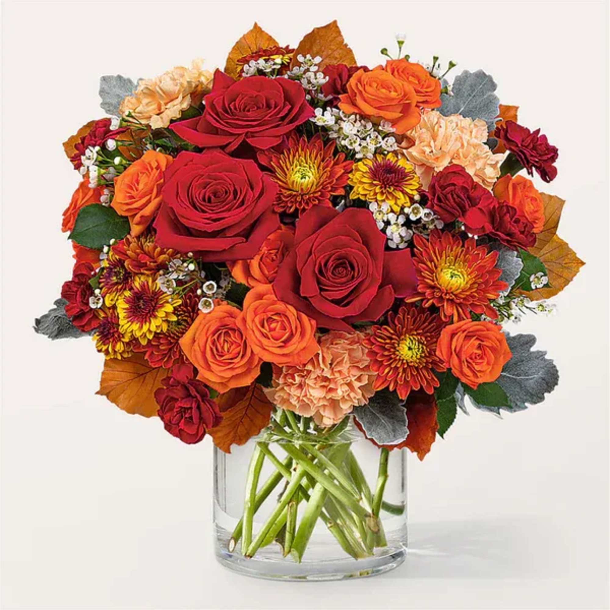 Bouquet of red and orange roses in a clear glass vase