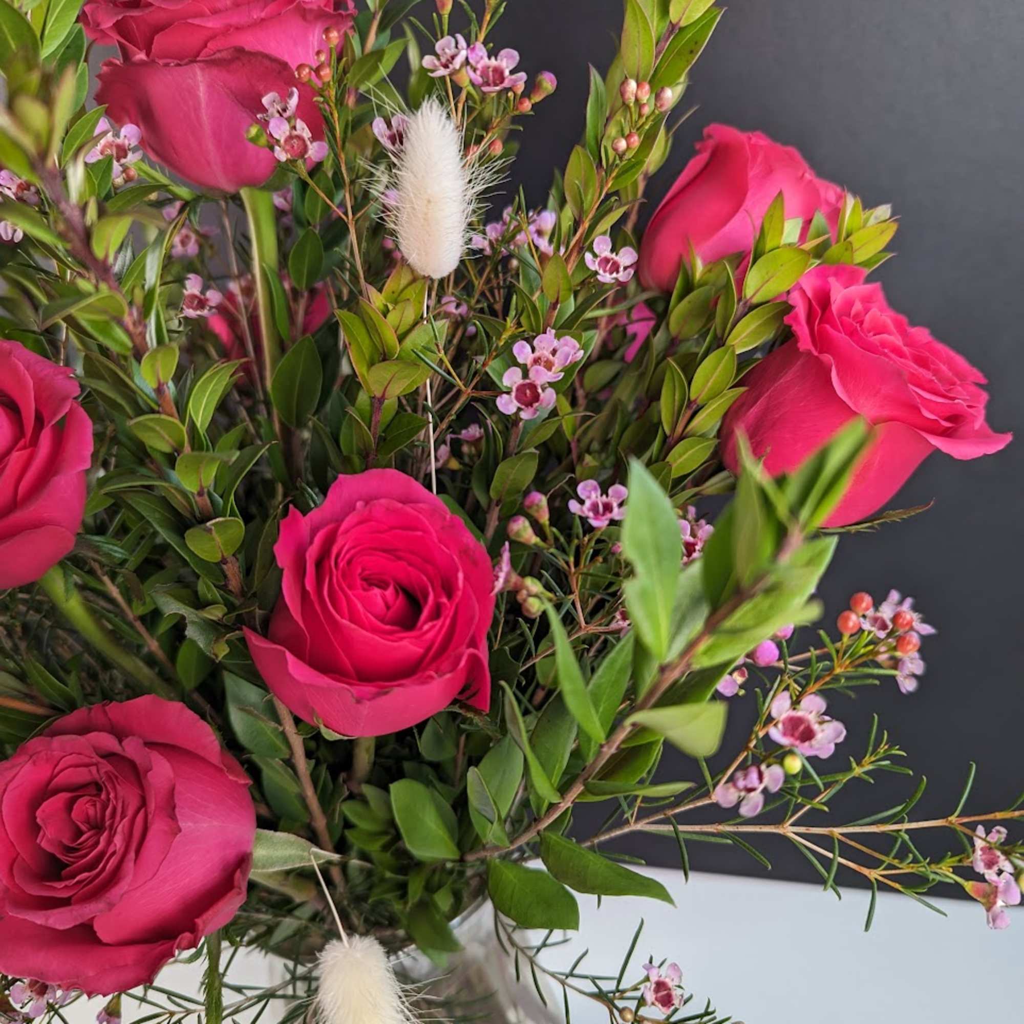 Bouquet of hot pink roses with small pink filler flowers