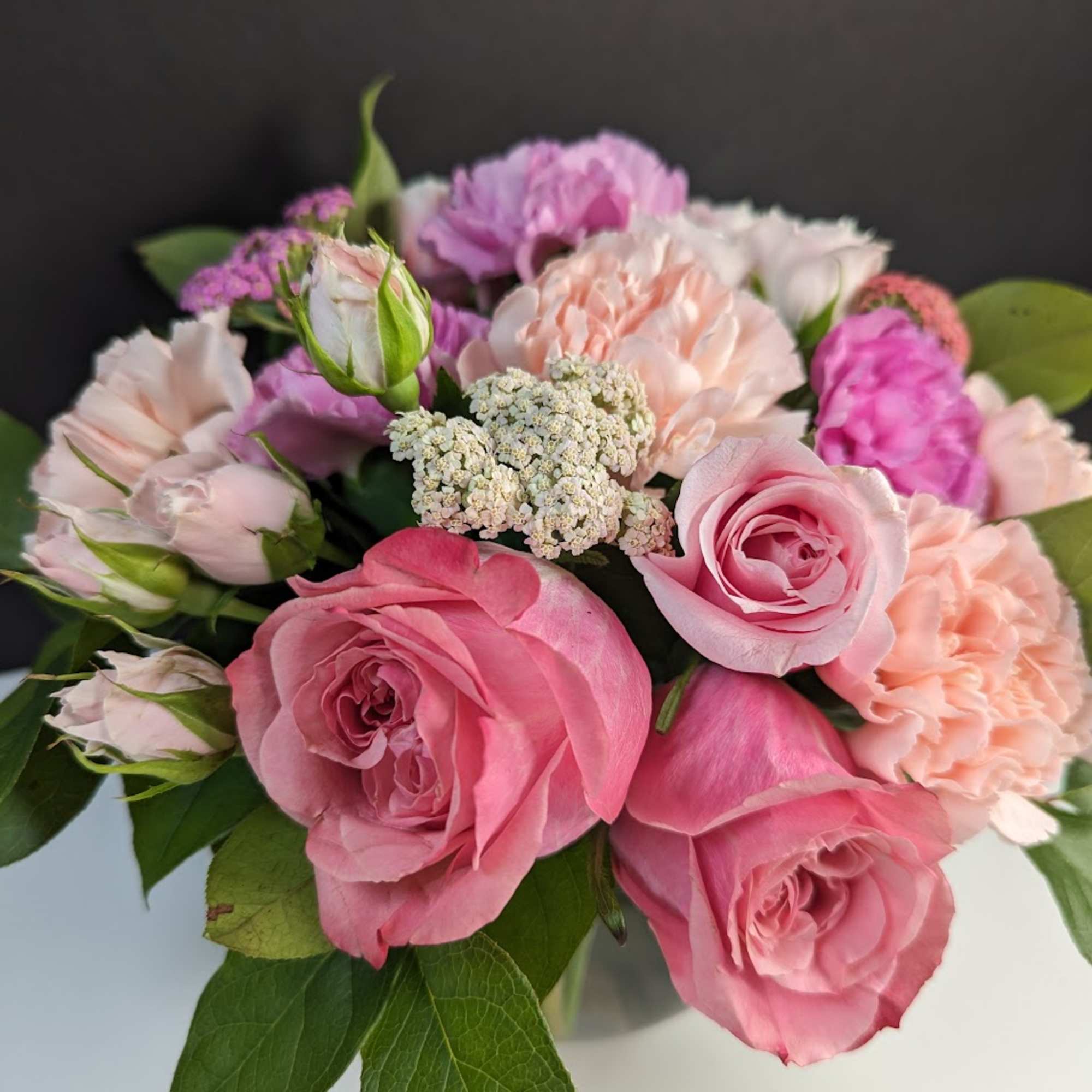 Pink and peach roses with carnations in a bouquet