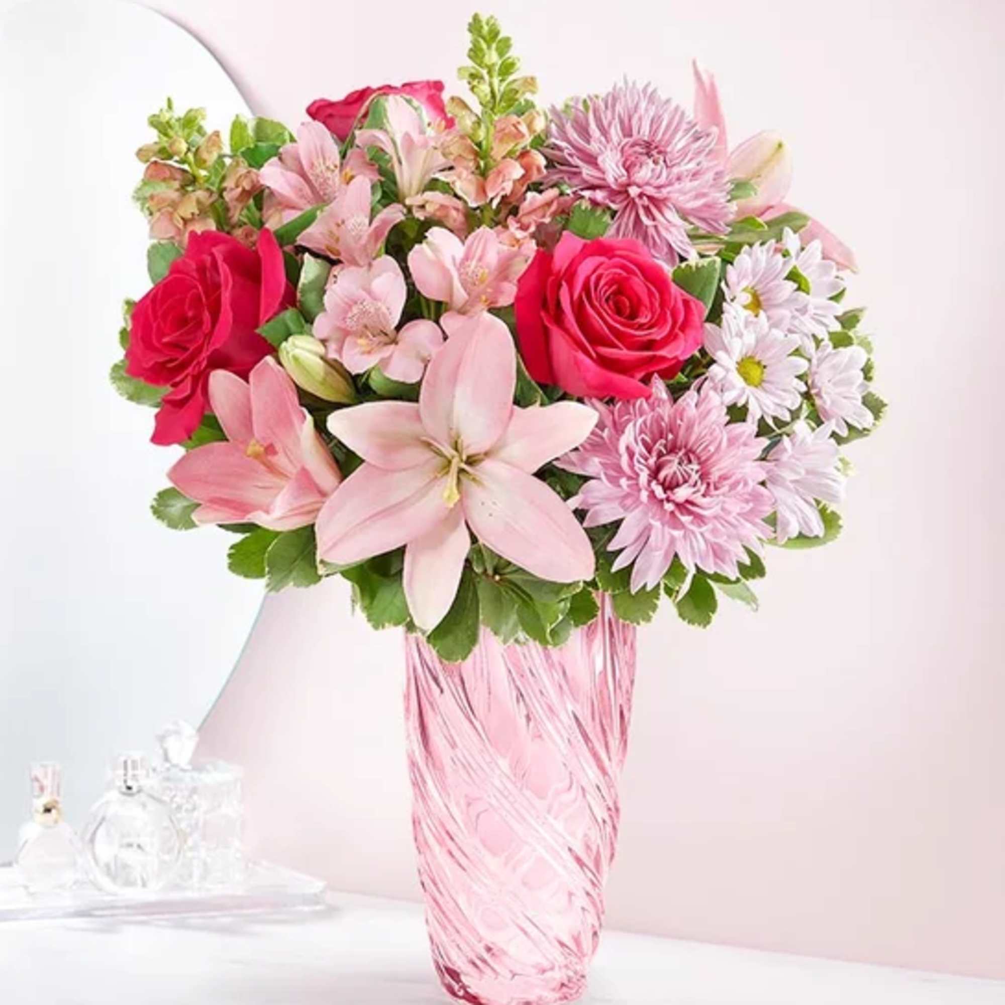 This beautiful arrangement made with Lavender mum ,Hot pink roses , Pink