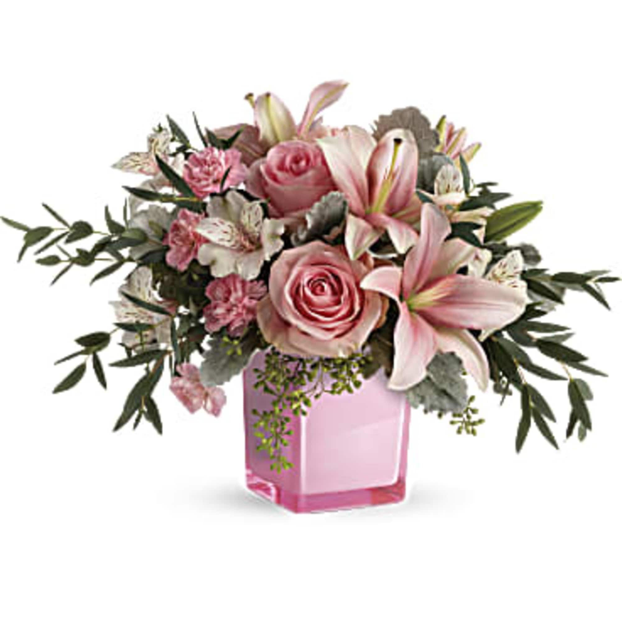 Pink roses and lilies arranged in a pink glass vase