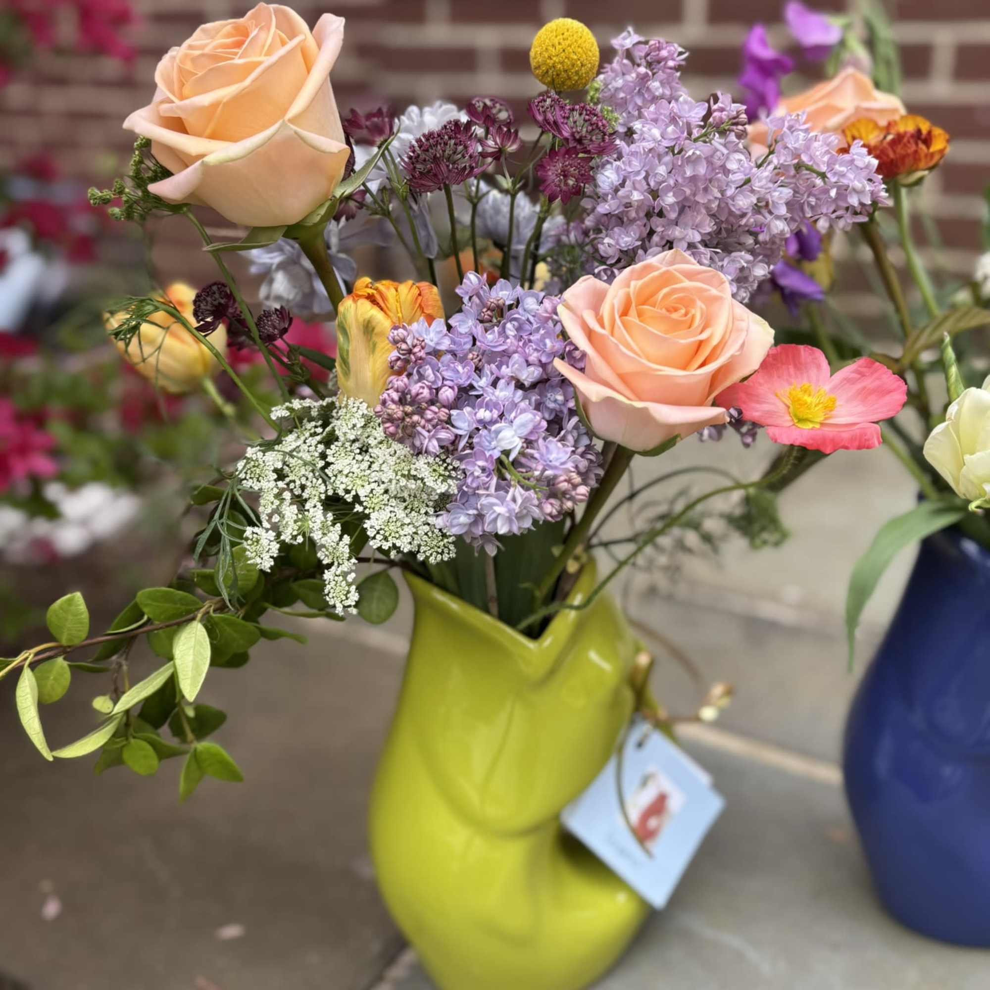 A colorful Gurgle Pot bursting with whimsical fresh local blooms.  The