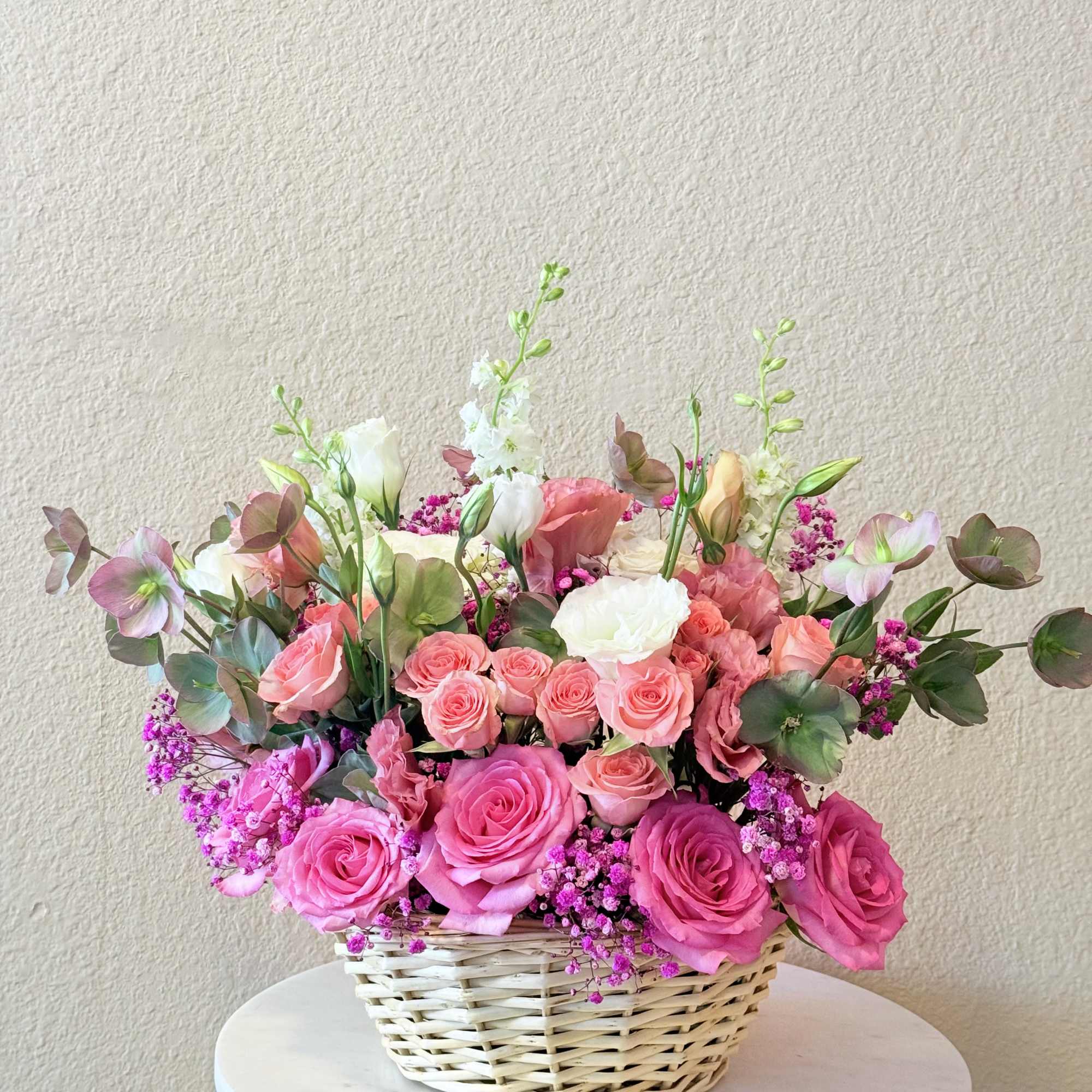 With its dreamy palette of blush, soft peach, and vibrant pink tones