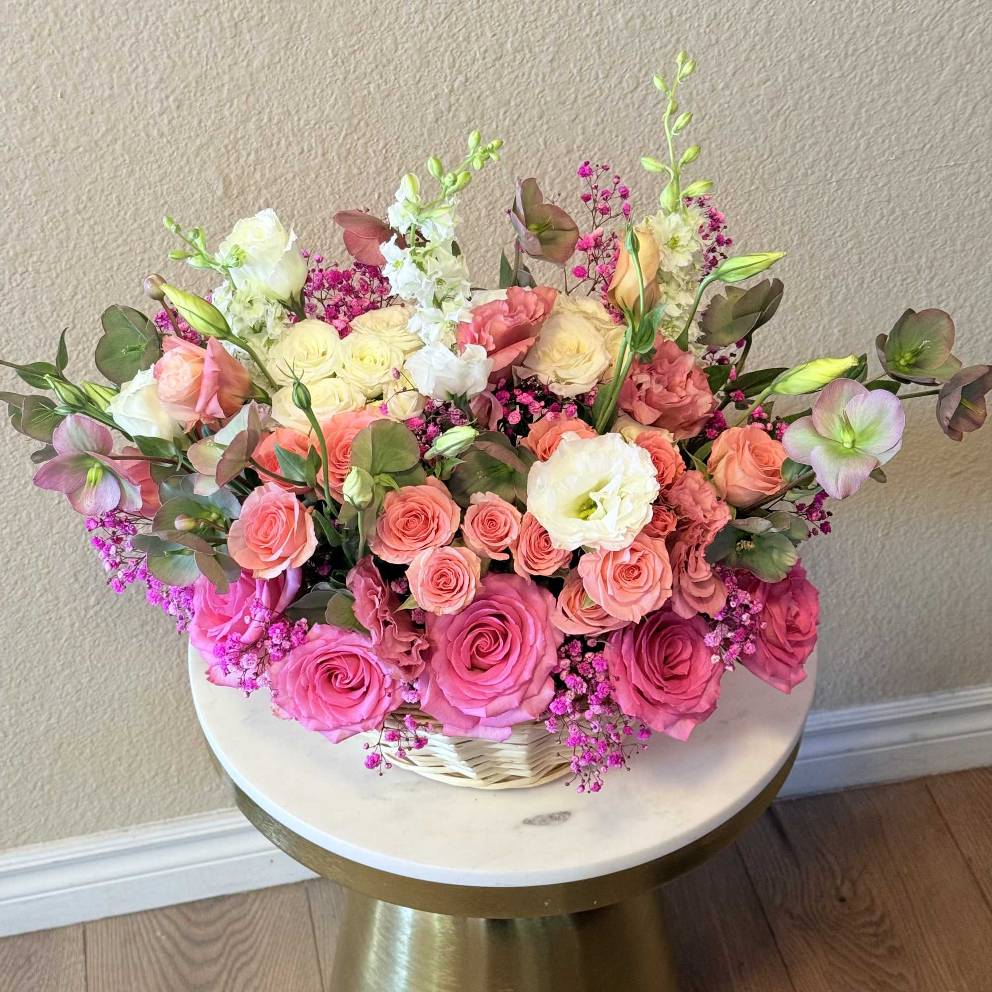 With its dreamy palette of blush, soft peach, and vibrant pink tones