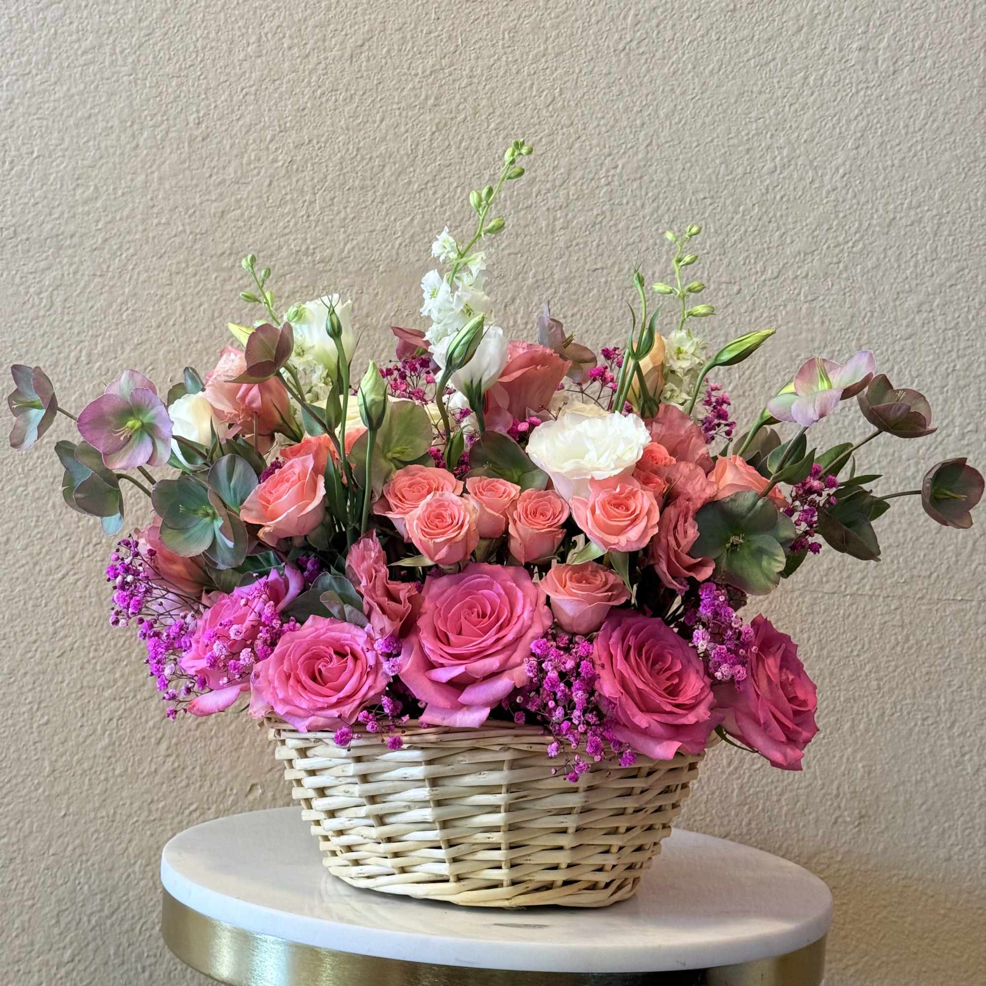 With its dreamy palette of blush, soft peach, and vibrant pink tones