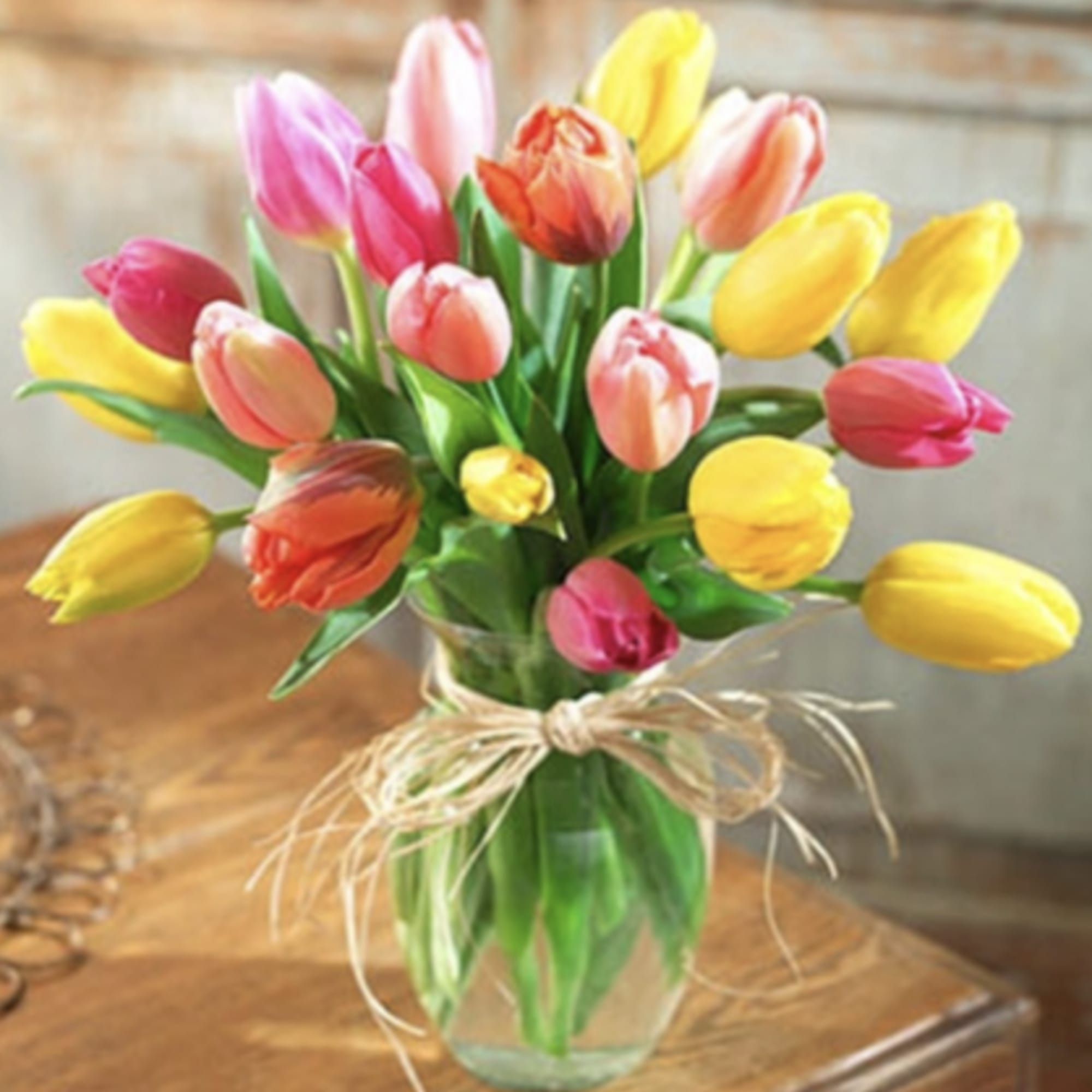 Bouquet of multicolored tulips in a clear glass vase