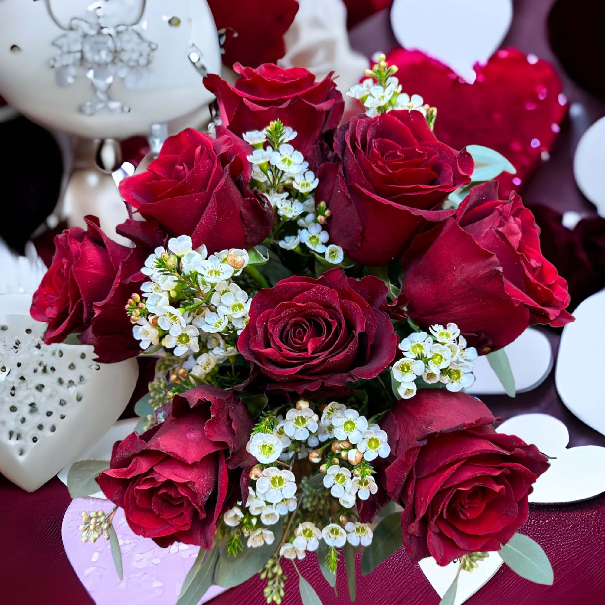 Bouquet of red roses with small white filler flowers