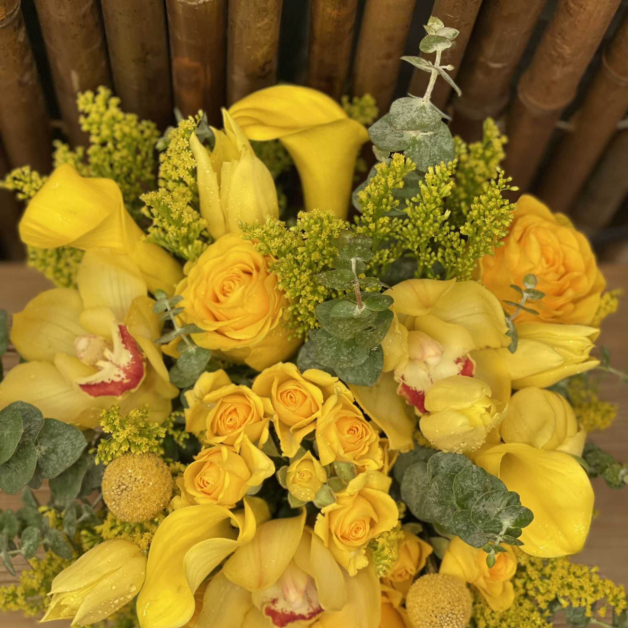 Yellow bouquet with roses, calla lilies, and orchids