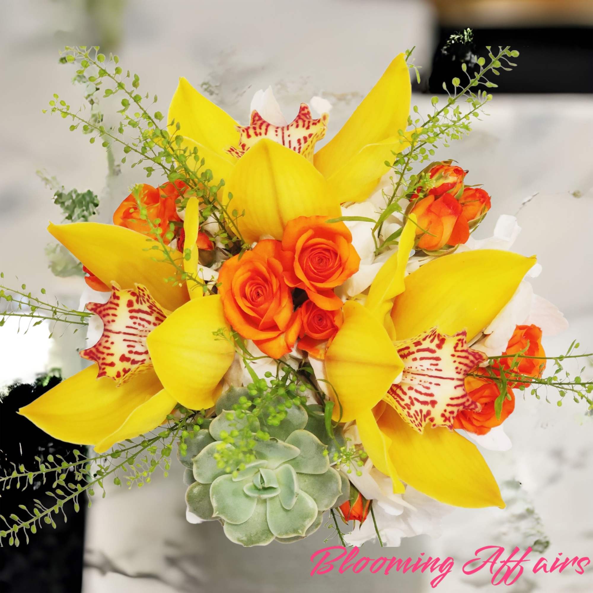 Bouquet of yellow calla lilies and orange roses with a succulent