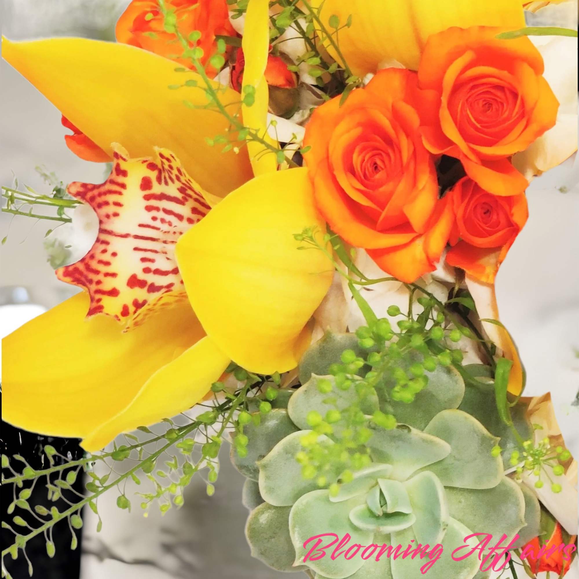 Bouquet with orange roses, yellow calla lilies, and a succulent cluster