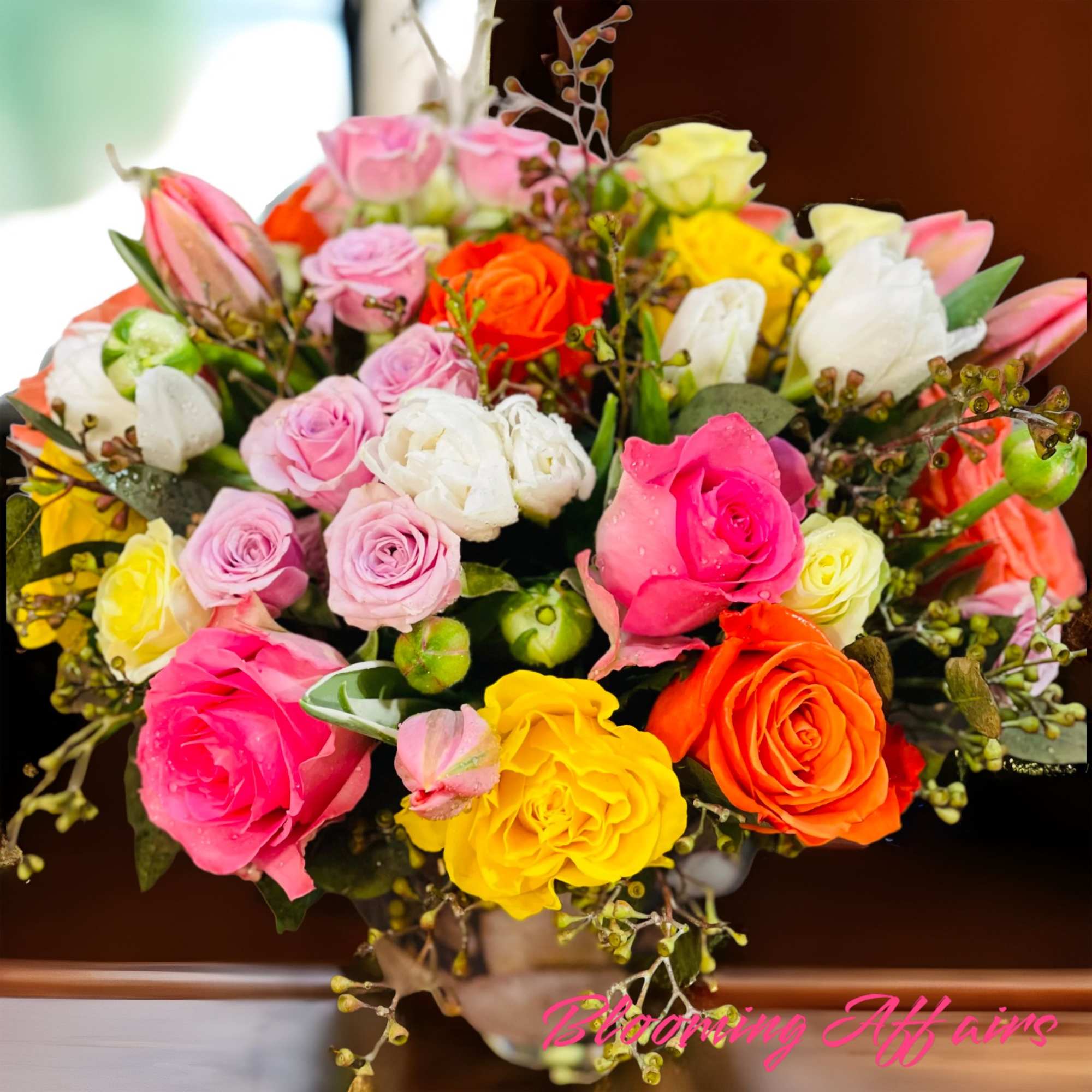 Bouquet of multicolored roses with a few buds and filler
