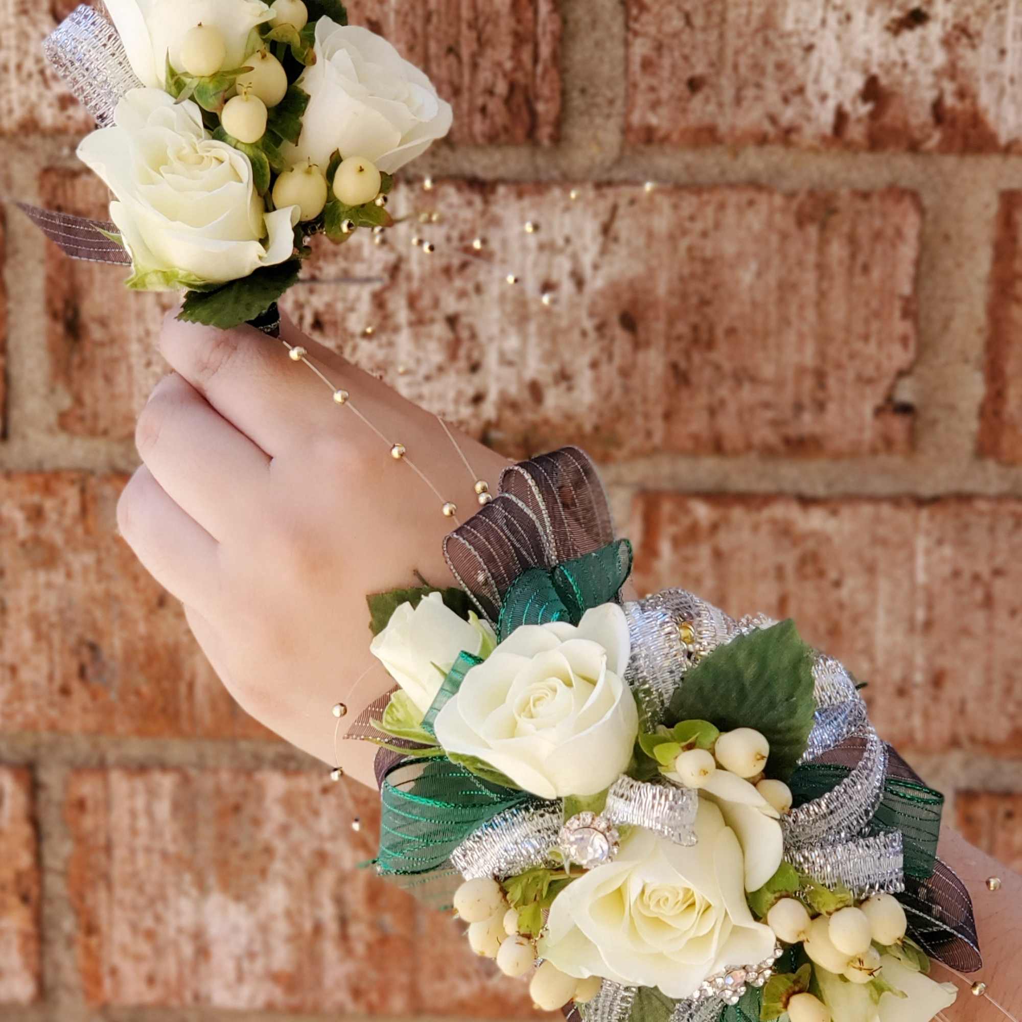 White rose wrist corsage and matching boutonniere with ribbon accents