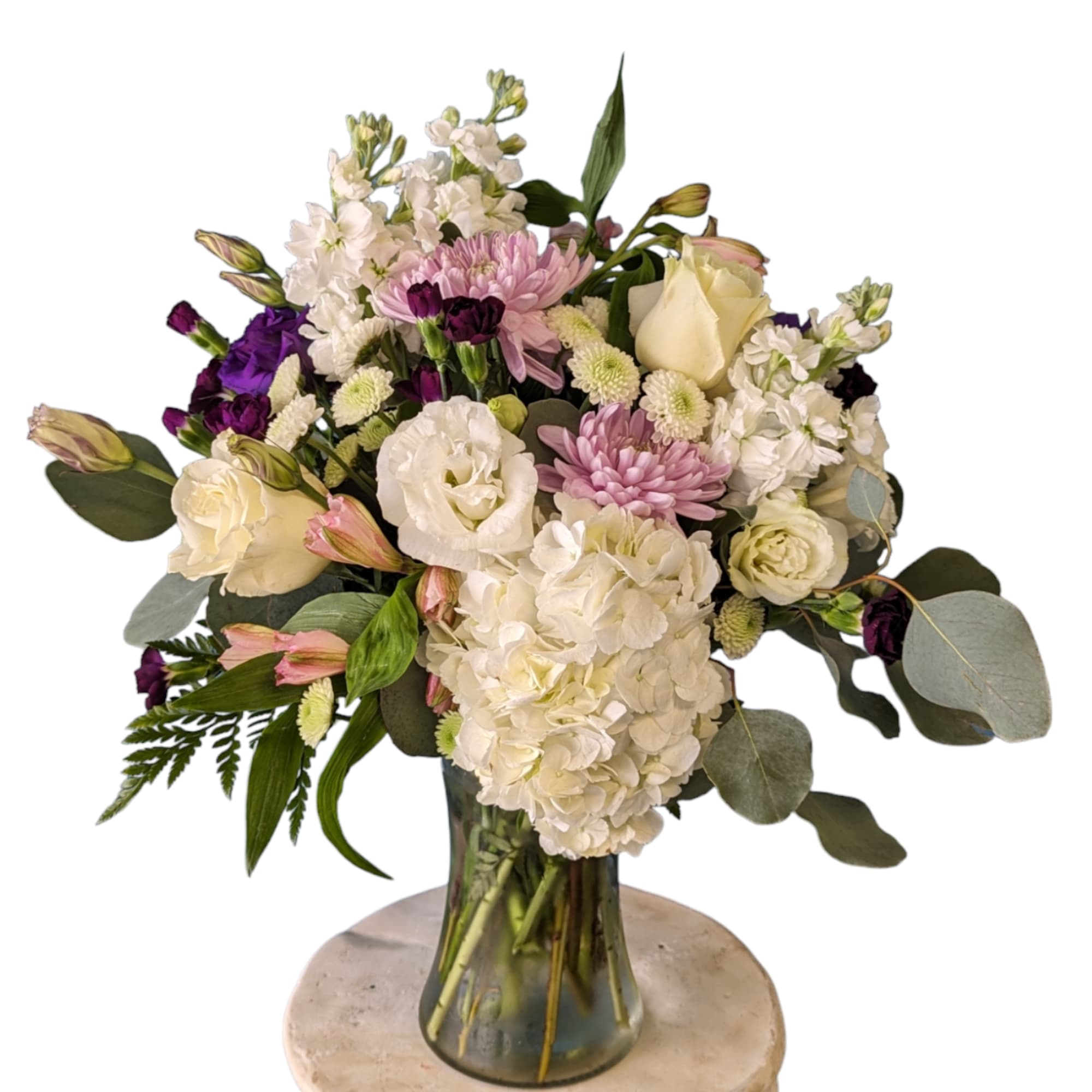 Bouquet of white, pink, and purple flowers in a glass vase