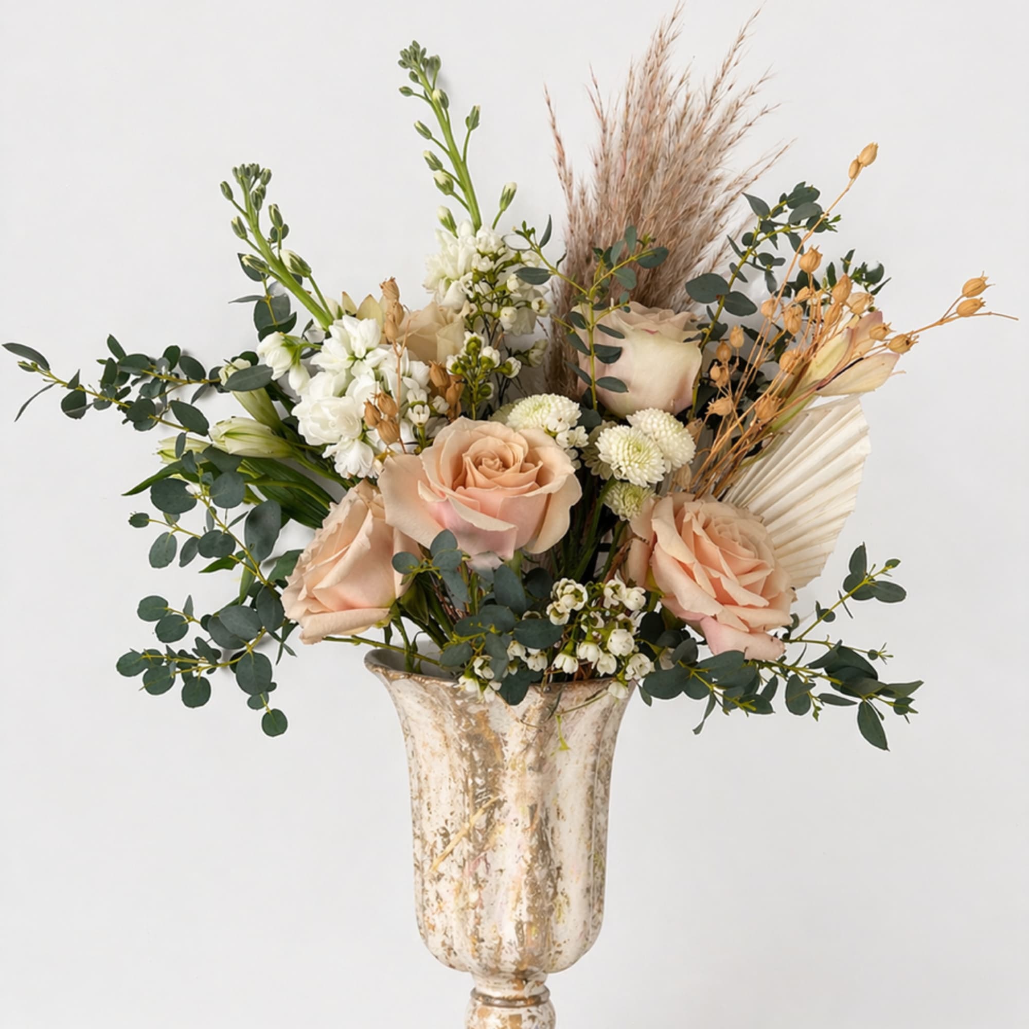 A mix of designer&rsquo;s choice blooms, in dusty pastels, tans and dried