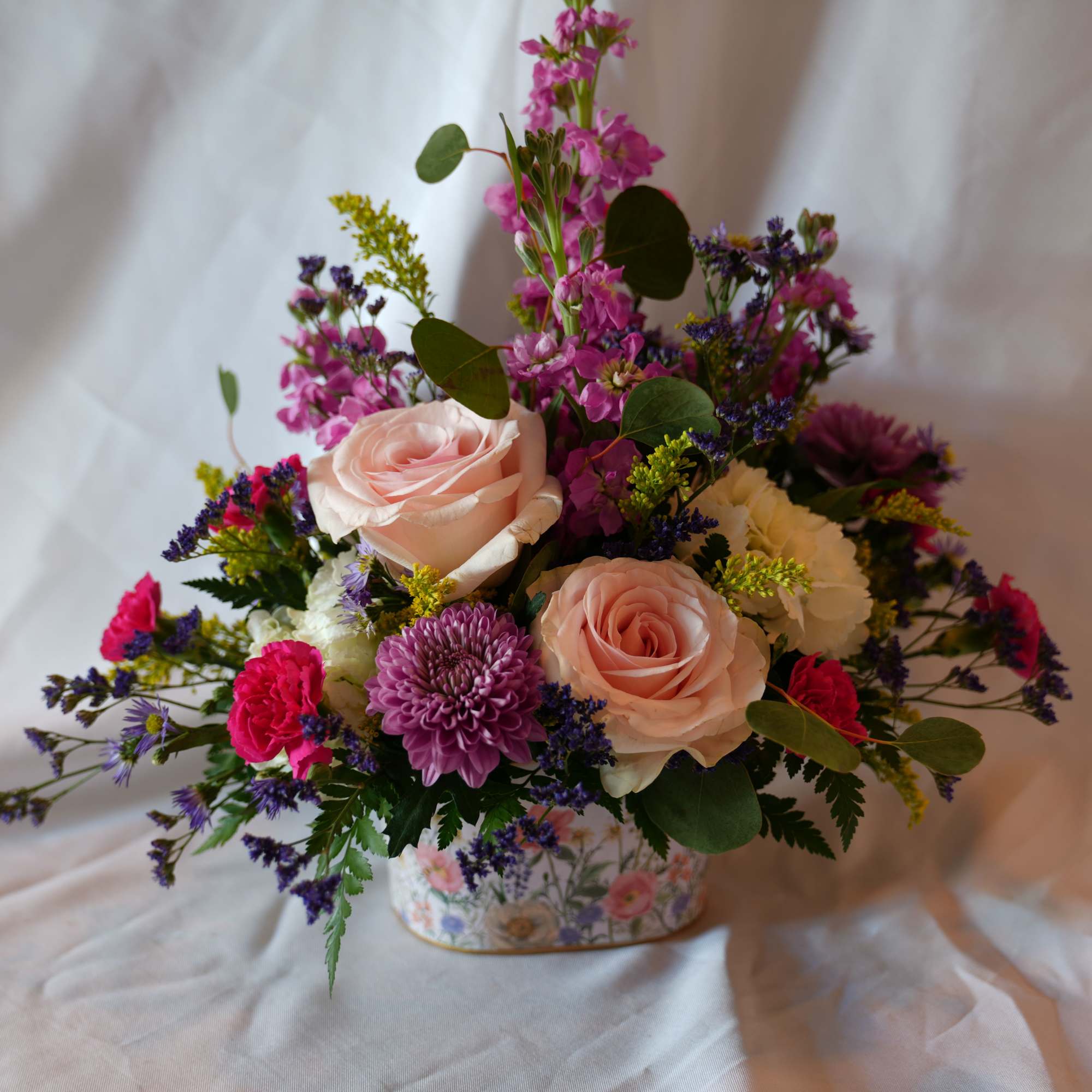 Wildflower Love is symbolic of joy and carefree simplicity. Blush roses and