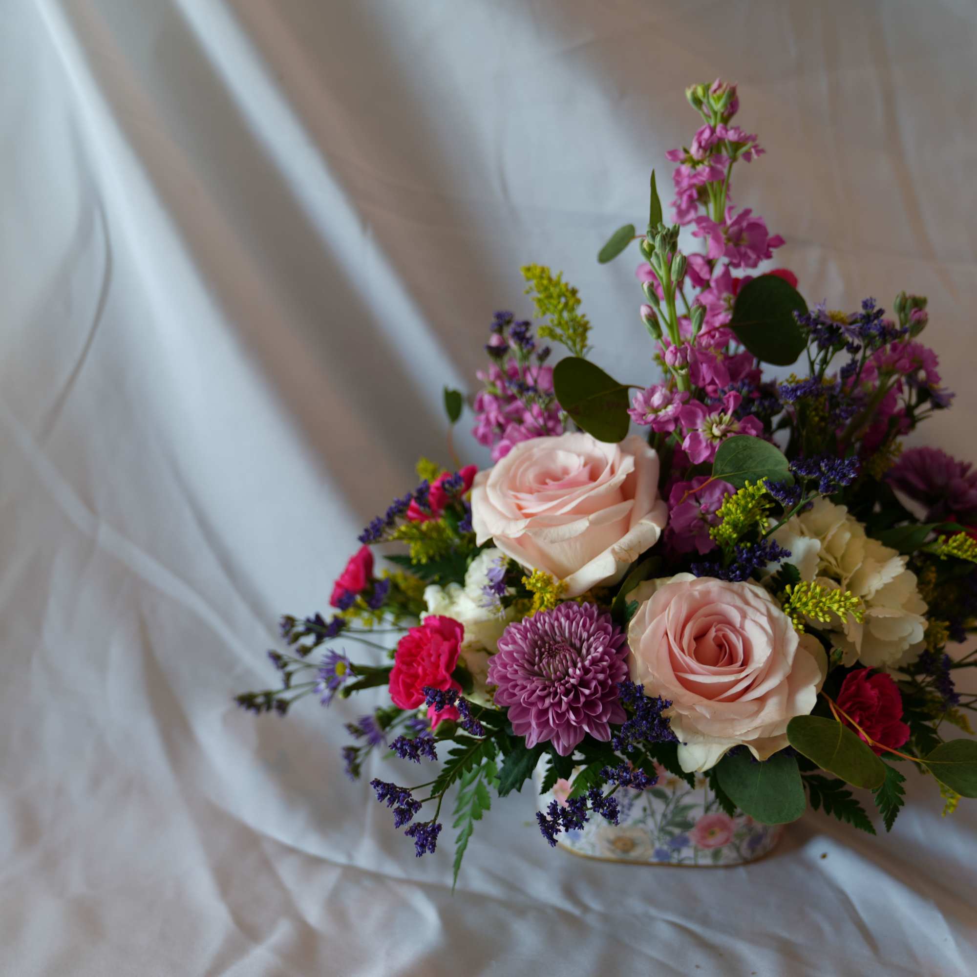 Wildflower Love is symbolic of joy and carefree simplicity. Blush roses and