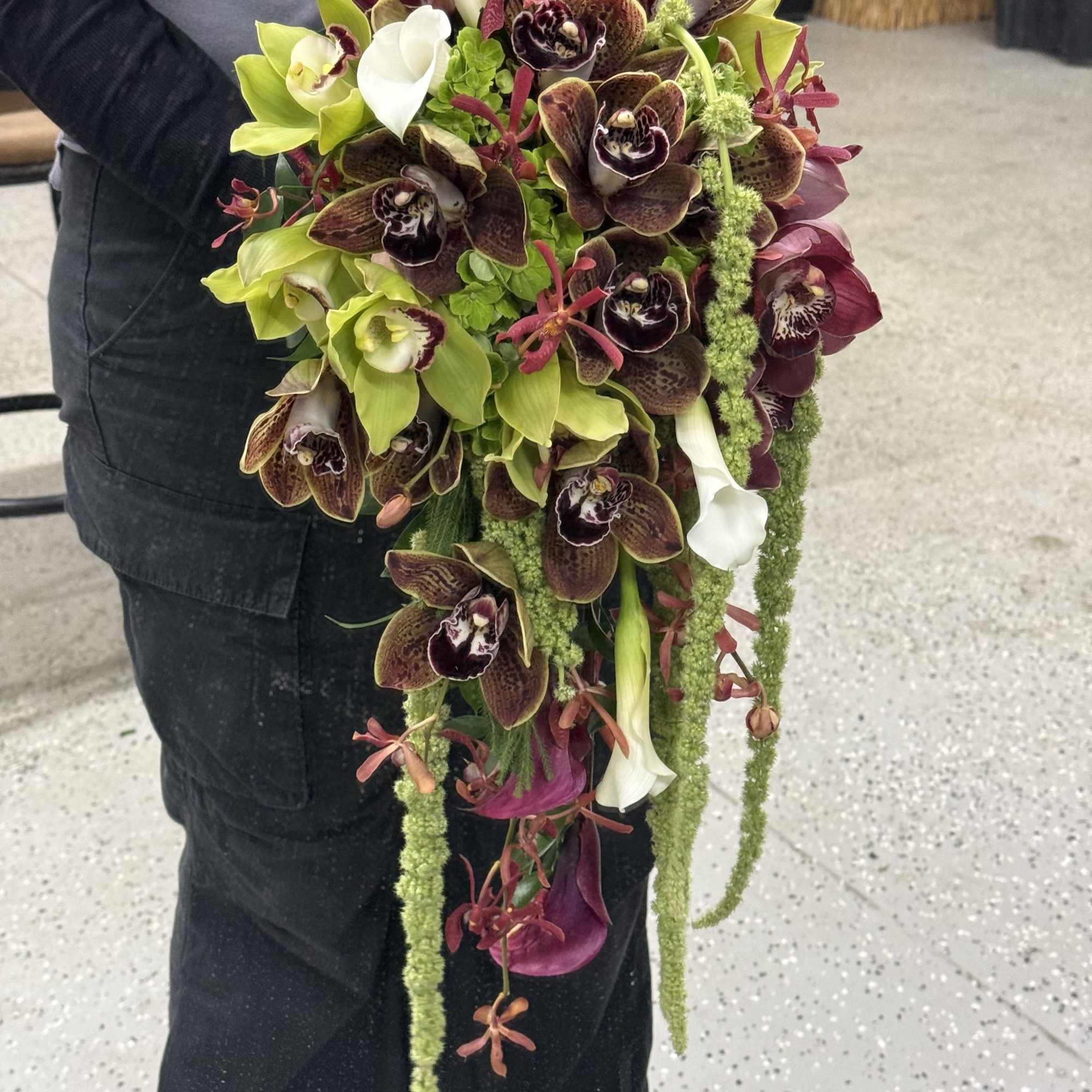 A unique blend of orchids, amaranthus, roses, and mini callas. Modern elegance