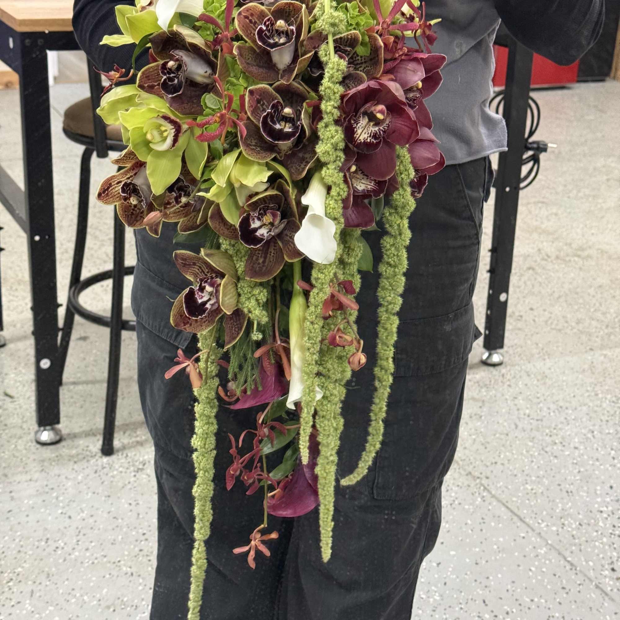 A unique blend of orchids, amaranthus, roses, and mini callas. Modern elegance