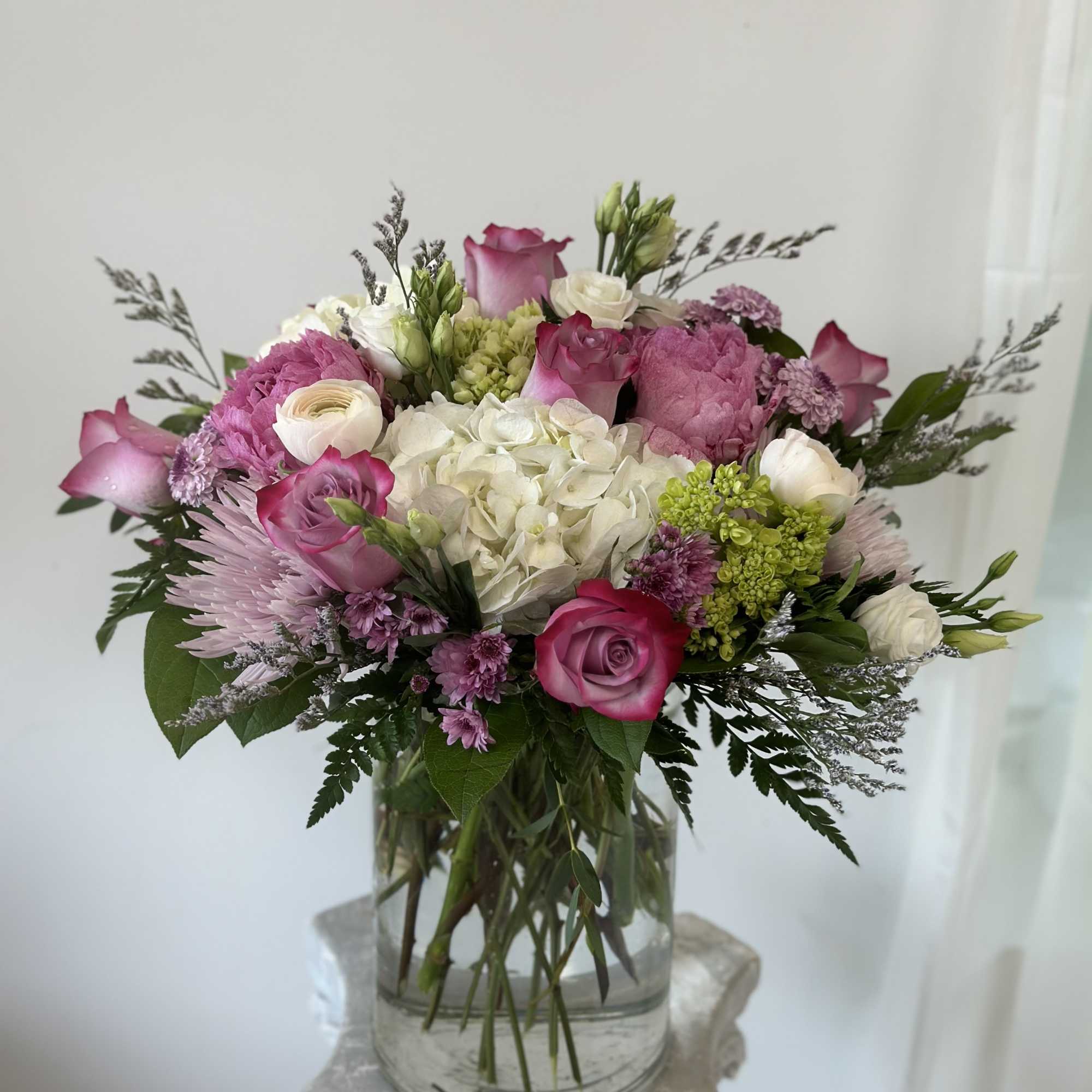 Pink and white mixed bouquet in a clear glass vase