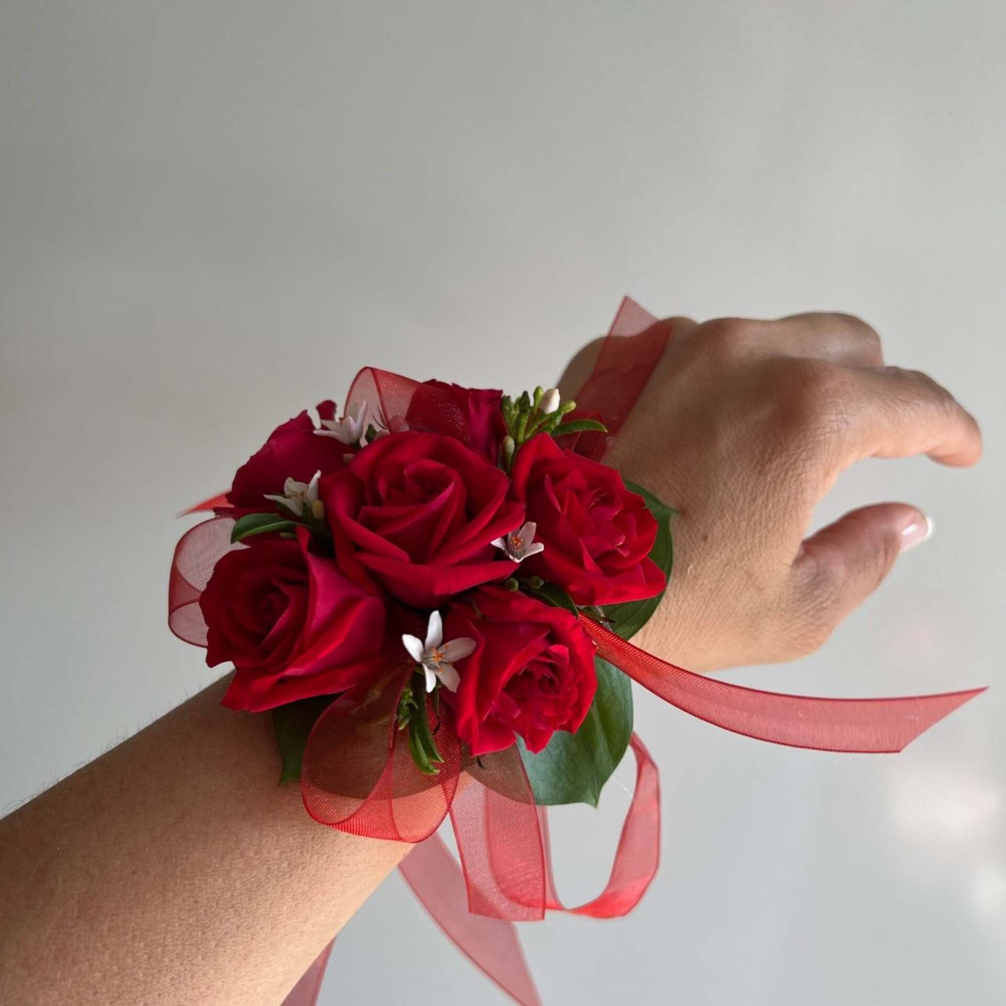 Matching corsage and boutonniere with blush tones and seasonal textures.