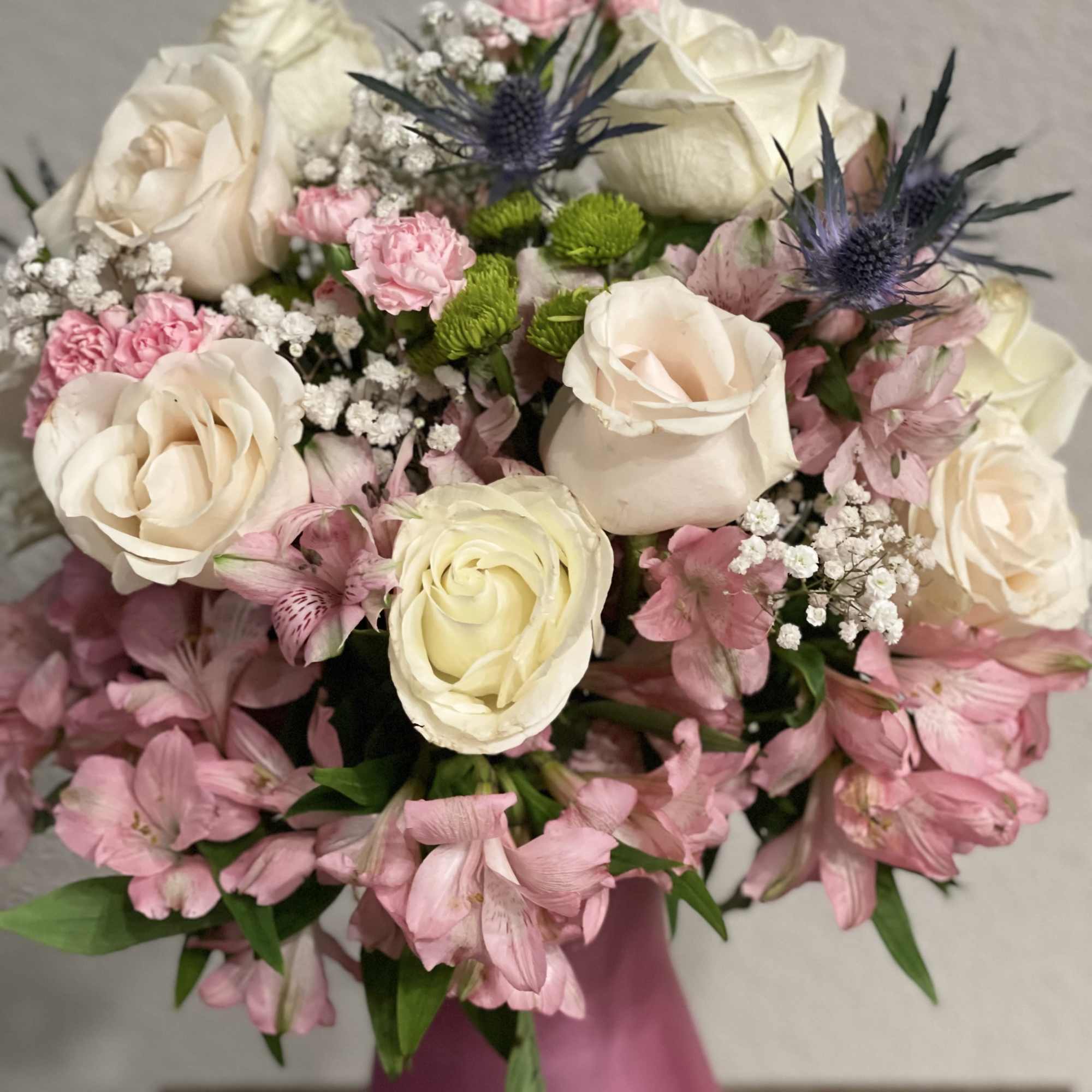 Lovely floral arrangement of long stem white roses, pink alstroemerias, baby&rsquo;s breath