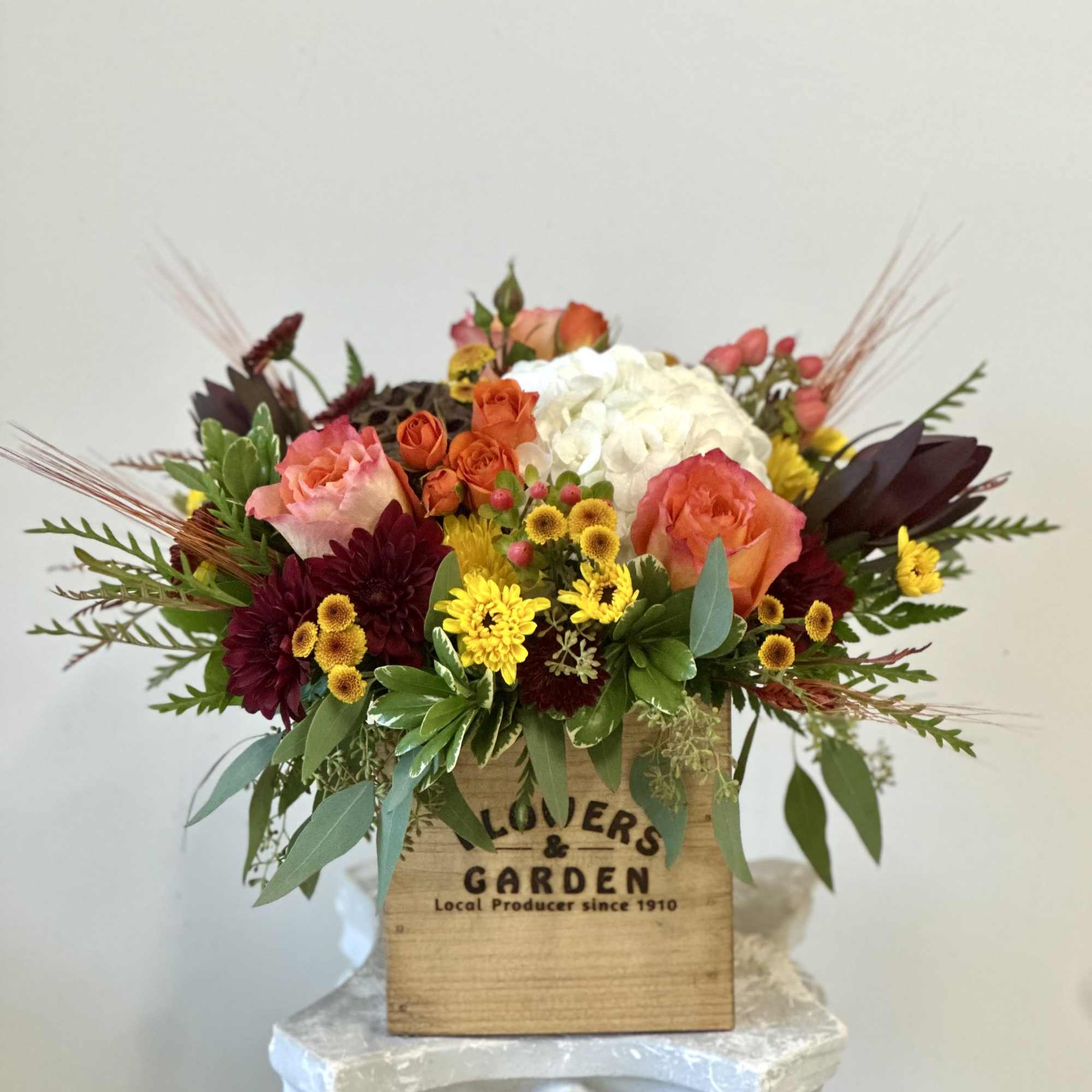 Embrace the warm embrace of fall with the exquisite Autumn Sunset arrangement