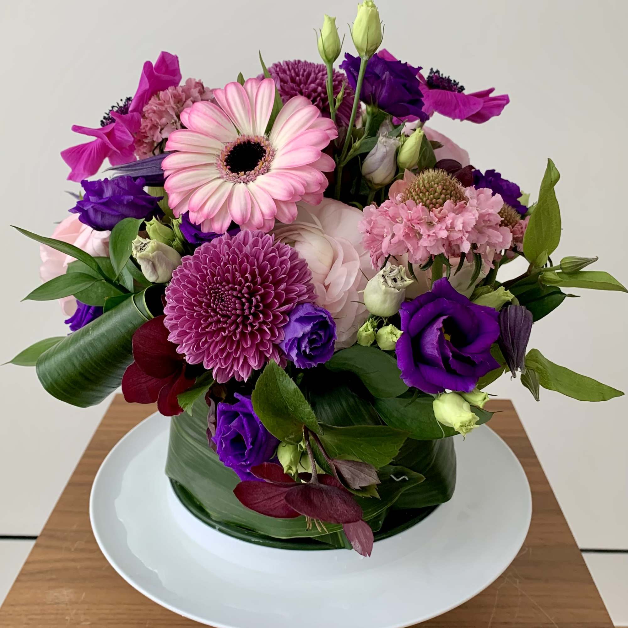 Pink and purple mixed bouquet in a glass vase