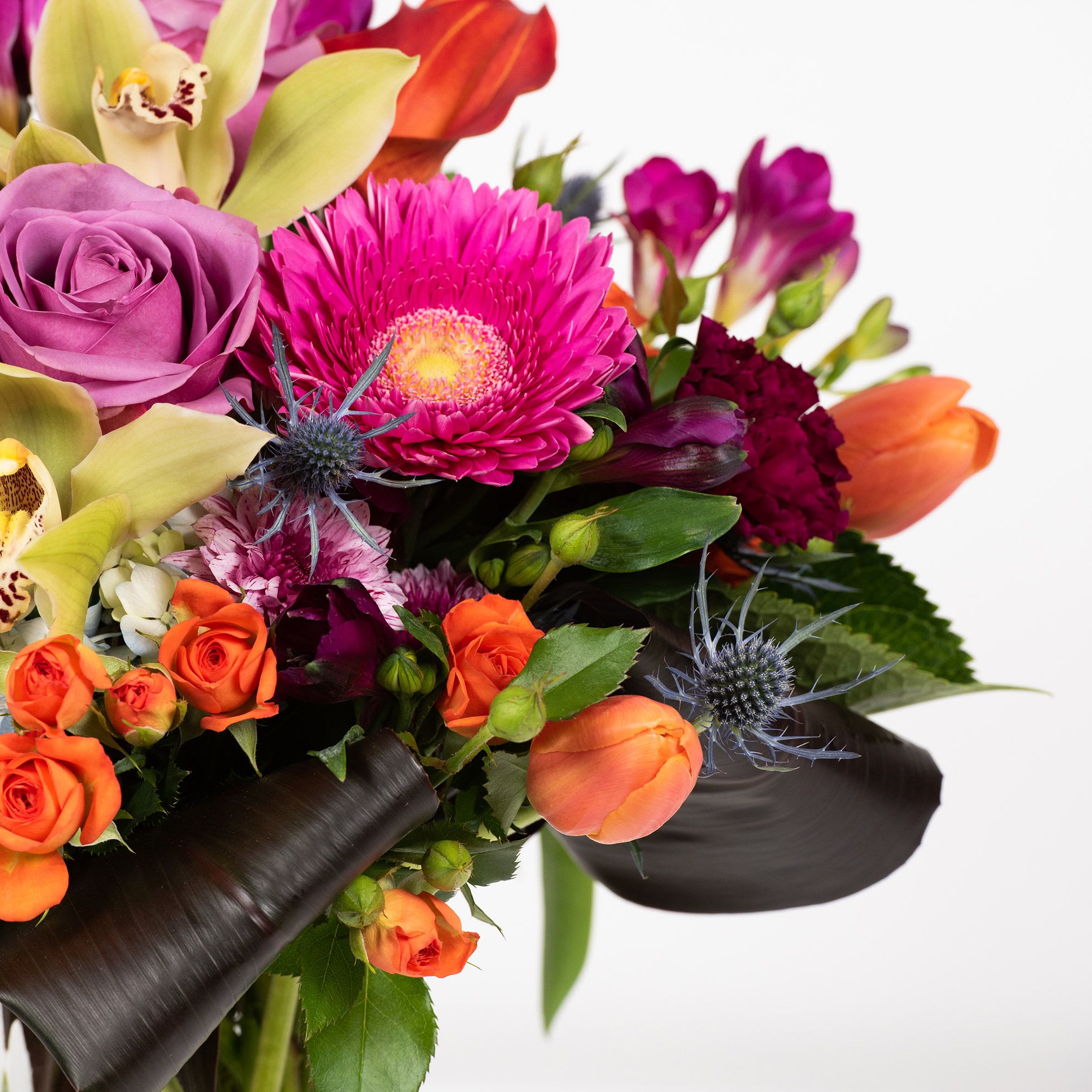 Colorful bouquet with roses, tulips, and a bright pink gerbera daisy
