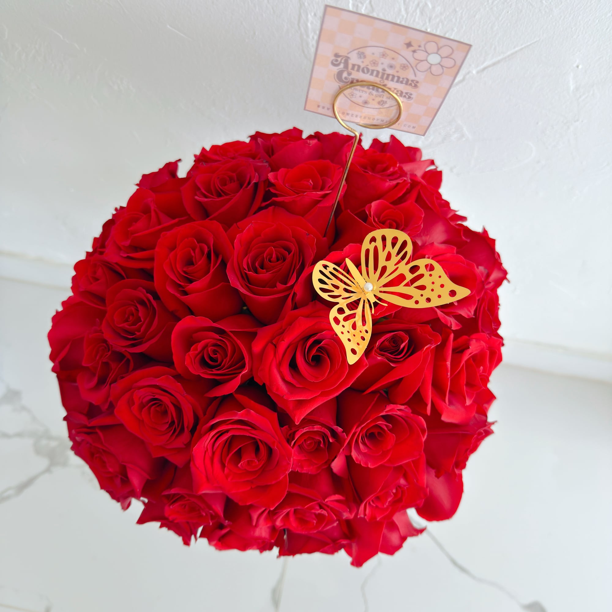 An elegant and captivating arrangement featuring 50 premium red roses, beautifully arranged