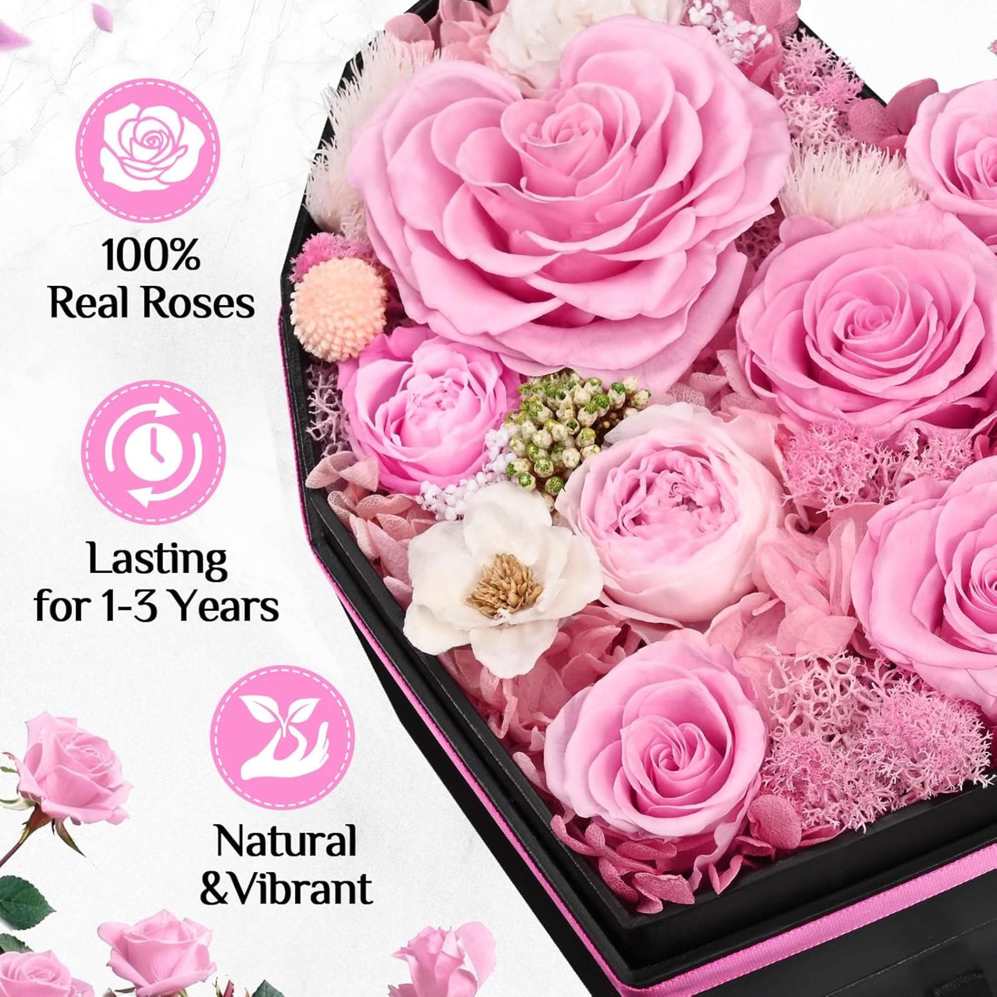 A lush cluster of preserved pink roses packed into a black heart-shaped