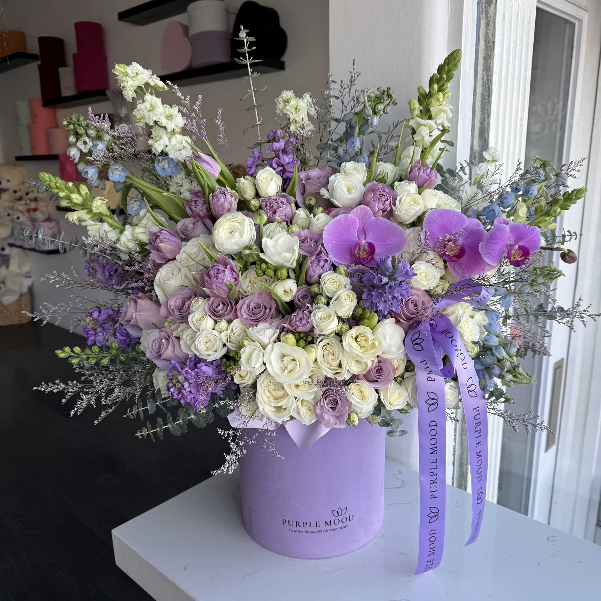 Lavender box with white and lavender flowers. 

Standard - Container size D6.75'x