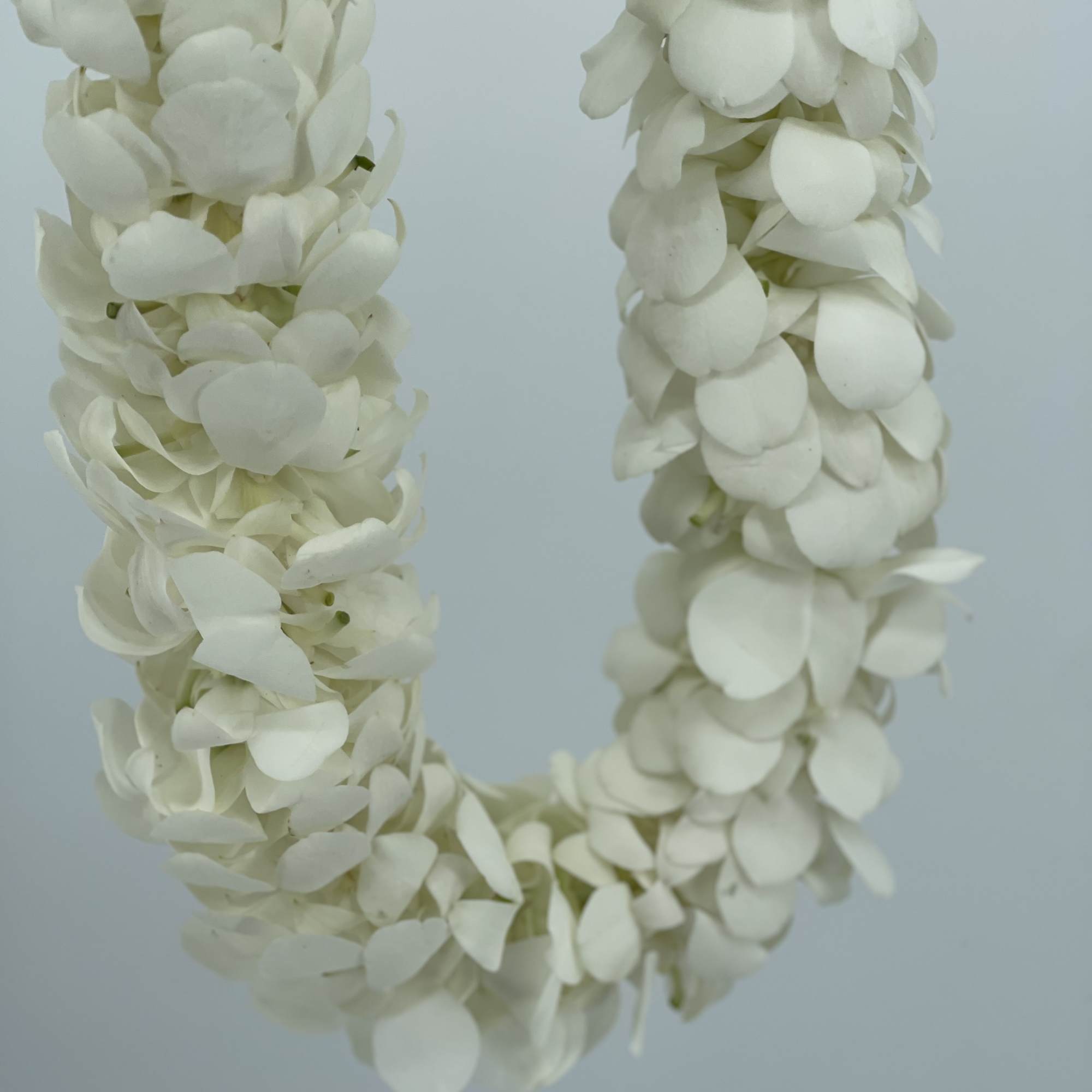 White flower lei made of clustered petals