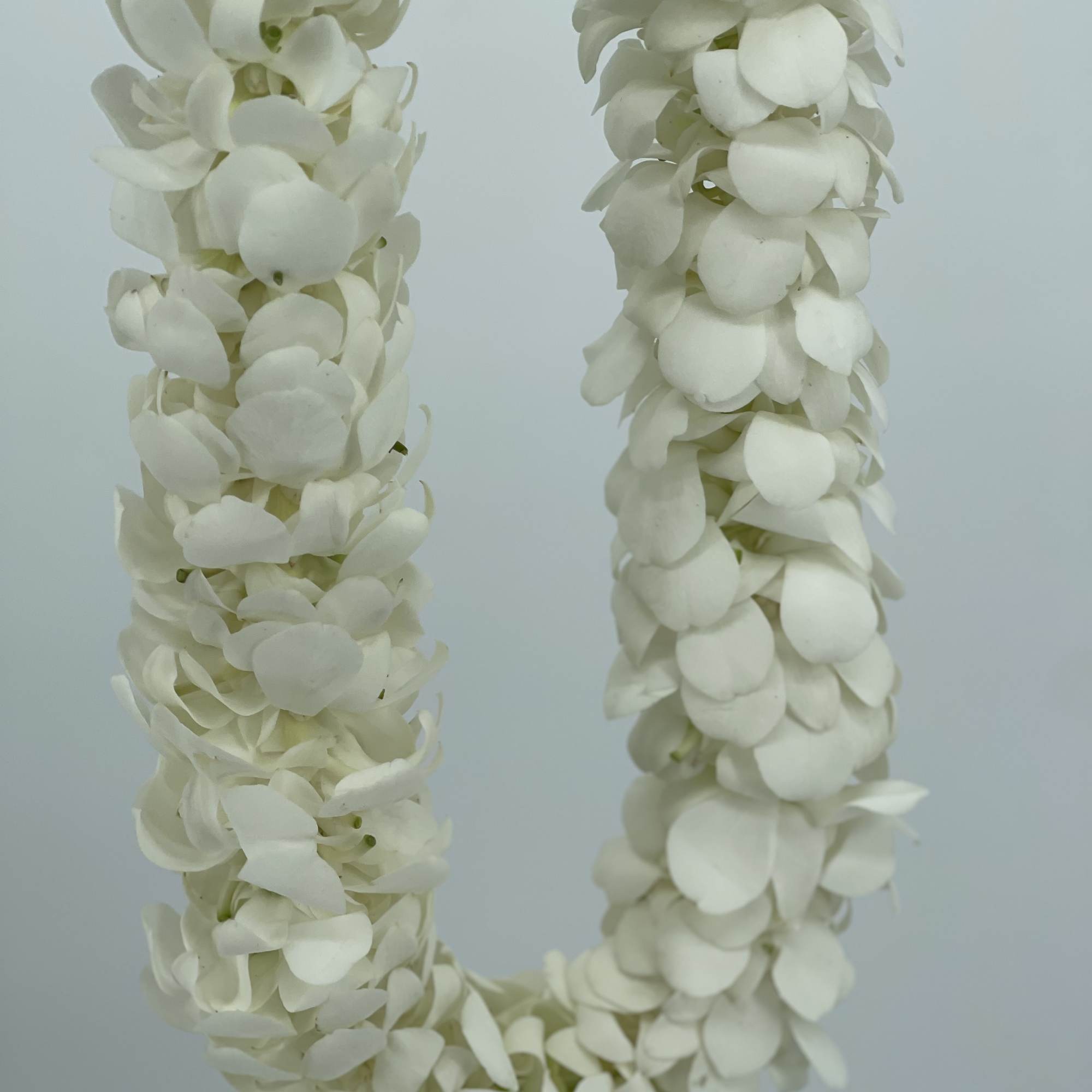 White flower garland made of clustered petals