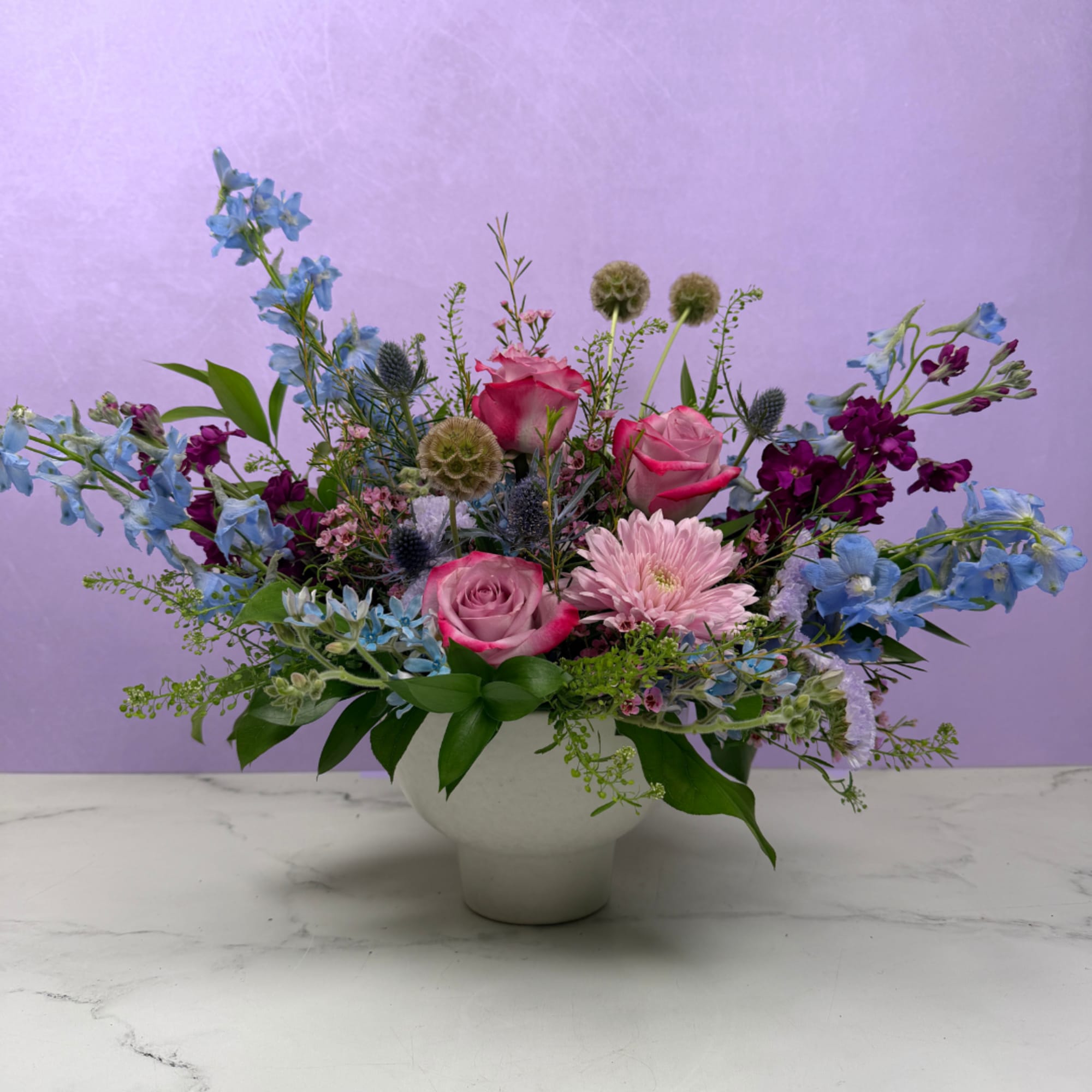 A lush, flowing arrangement of cool-toned blooms designed to feel peaceful and