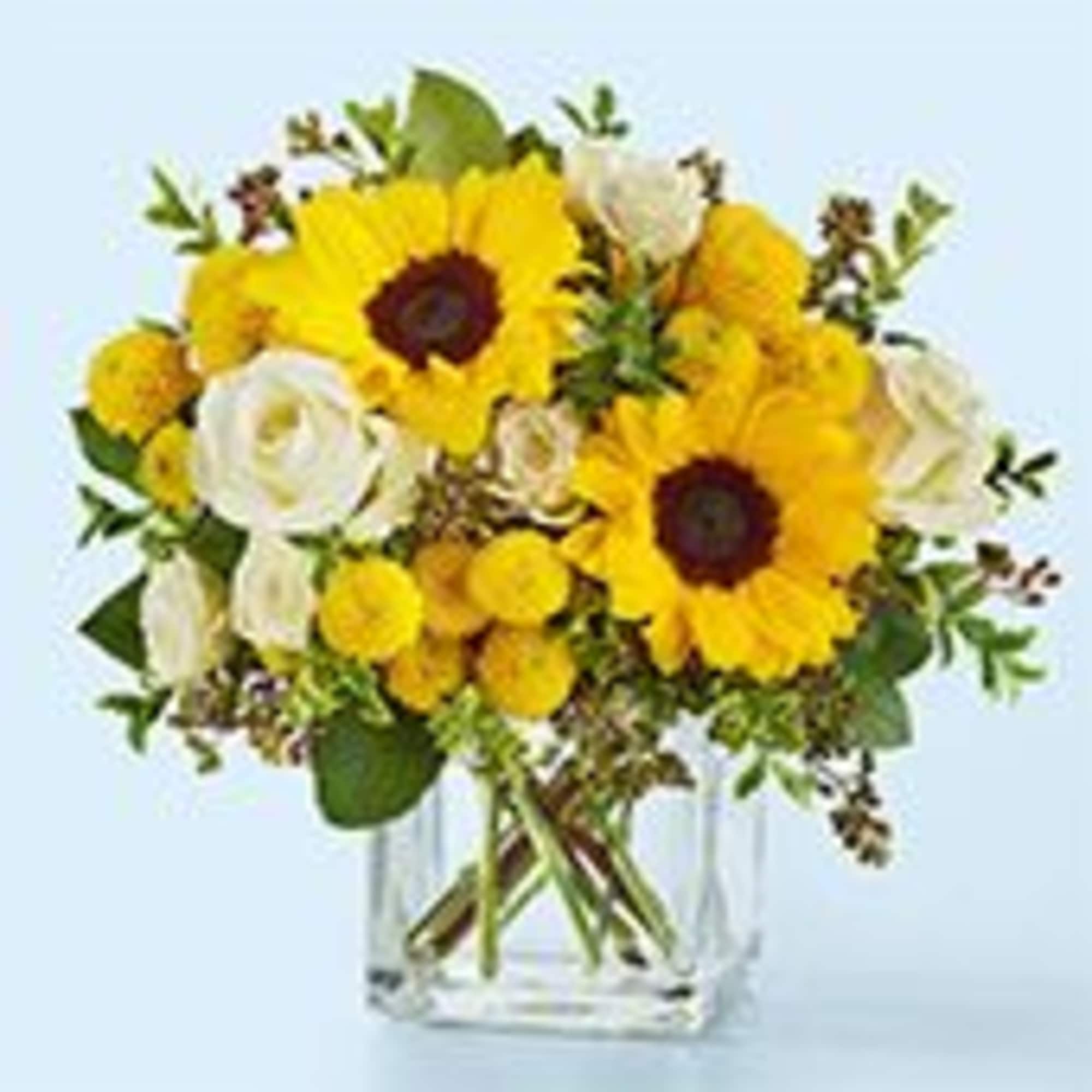 Two bold sunflowers take center stage in this cheerful flower arrangement for