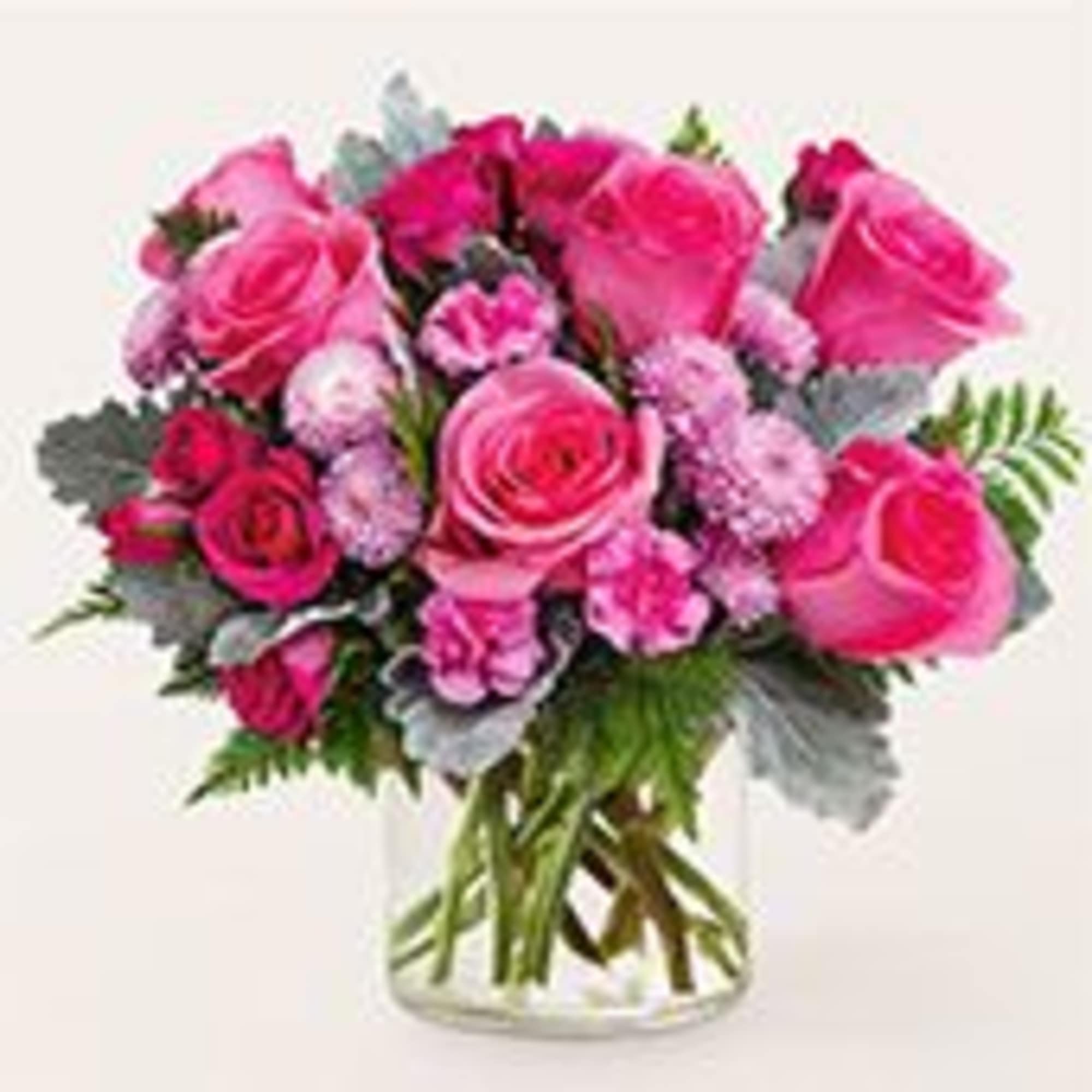 A lush cluster of bright pink roses and soft pink carnations creates