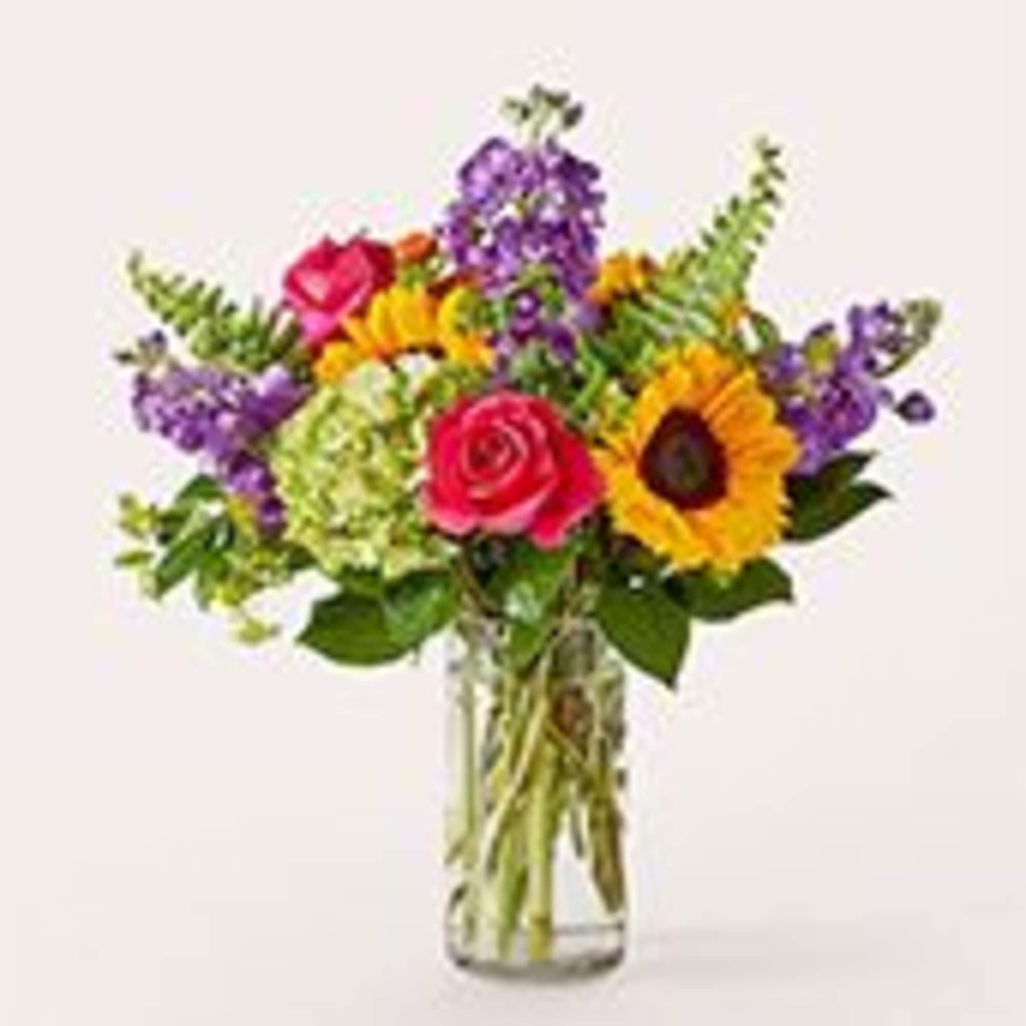 Sunny yellow sunflowers and a single vivid pink rose take center stage