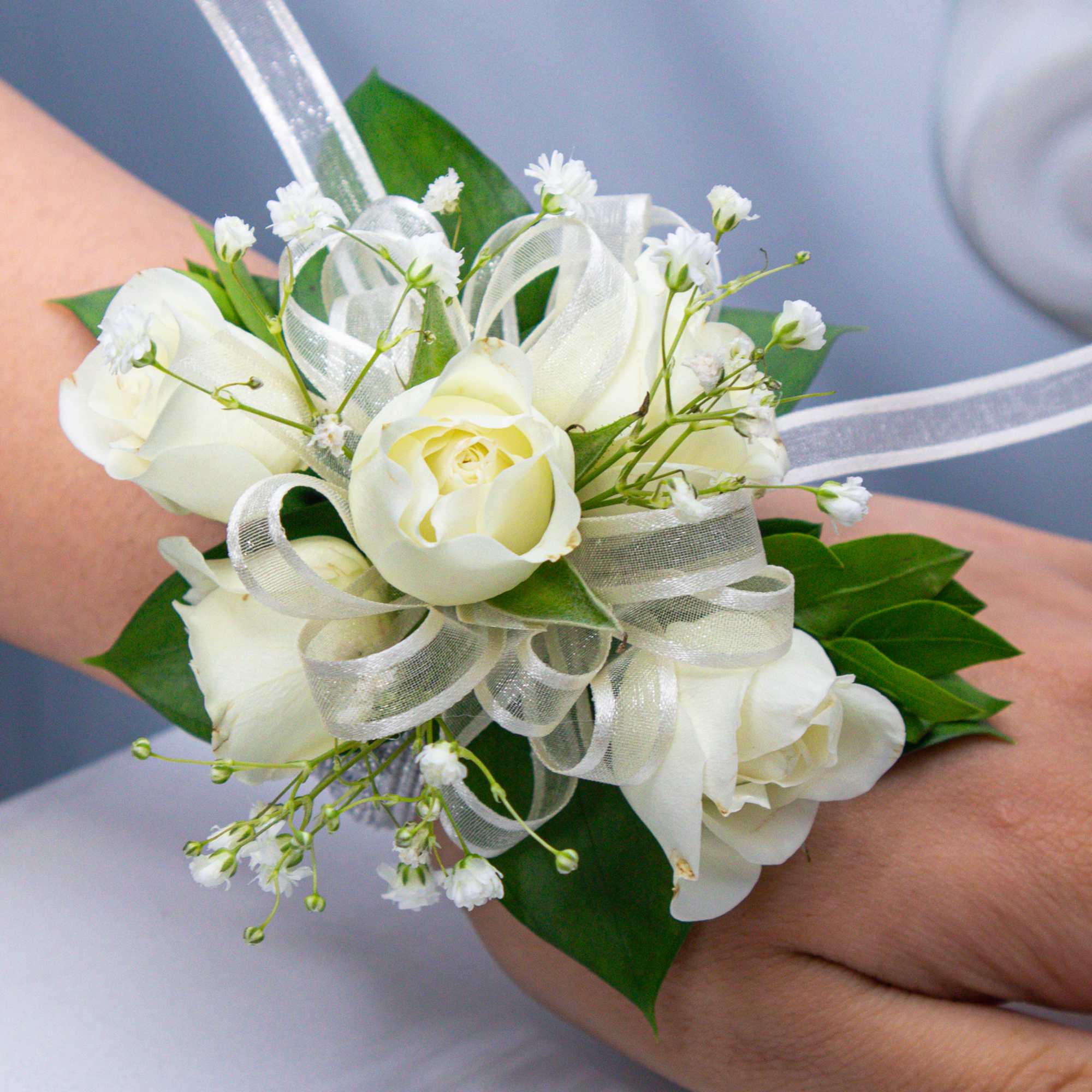 White rose wrist corsage with ribbon and baby's breath