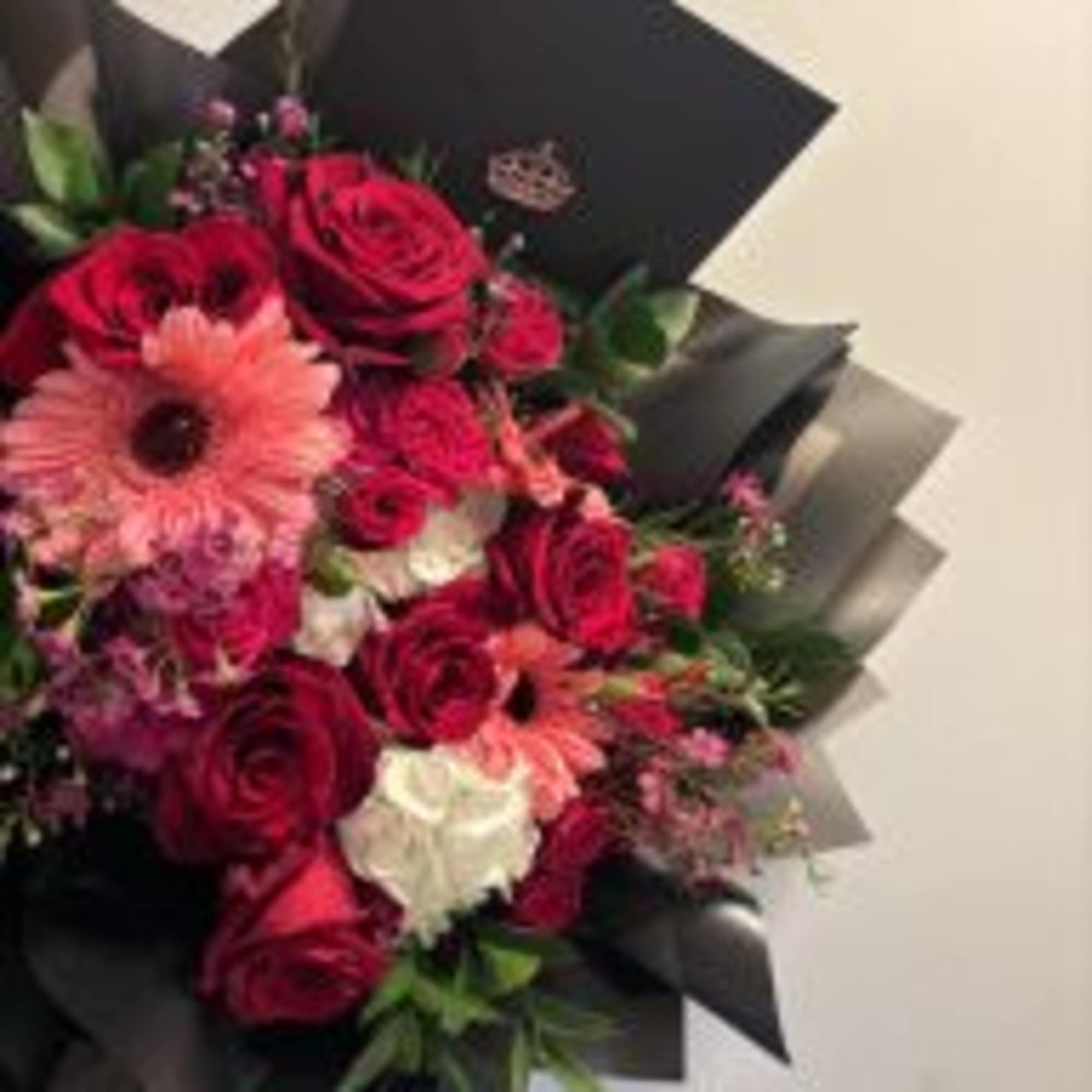 A beautifully handcrafted bouquet featuring a curated selection of fresh, mixed flowers.